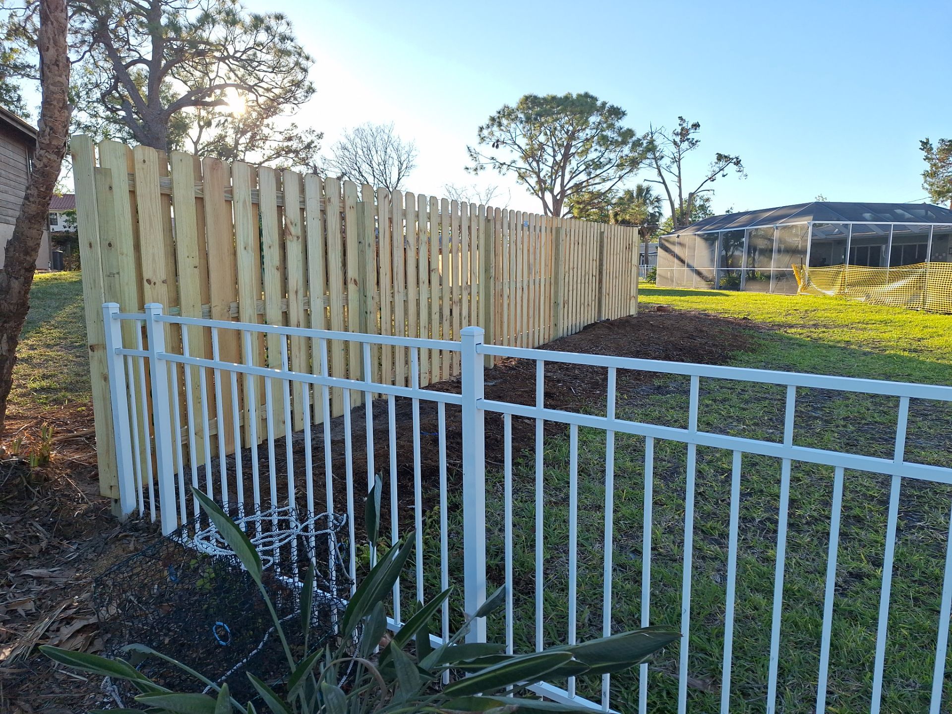 Wood Fence Installation using 6ft Pressure-Treated Wood Board-On-Board Privacy Fence with a 4Ft 3 Rail White Aluminum Fence by Asap fence and gates, LLC