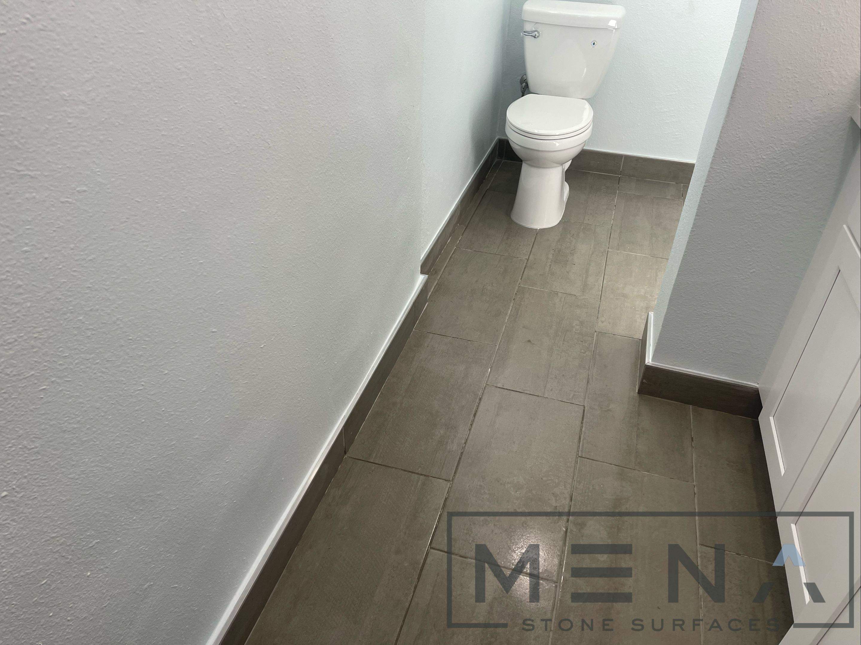 Complete Bathroom Remodel Featuring Marble Tile and Teal Herringbone Niche by Mena stone surfaces