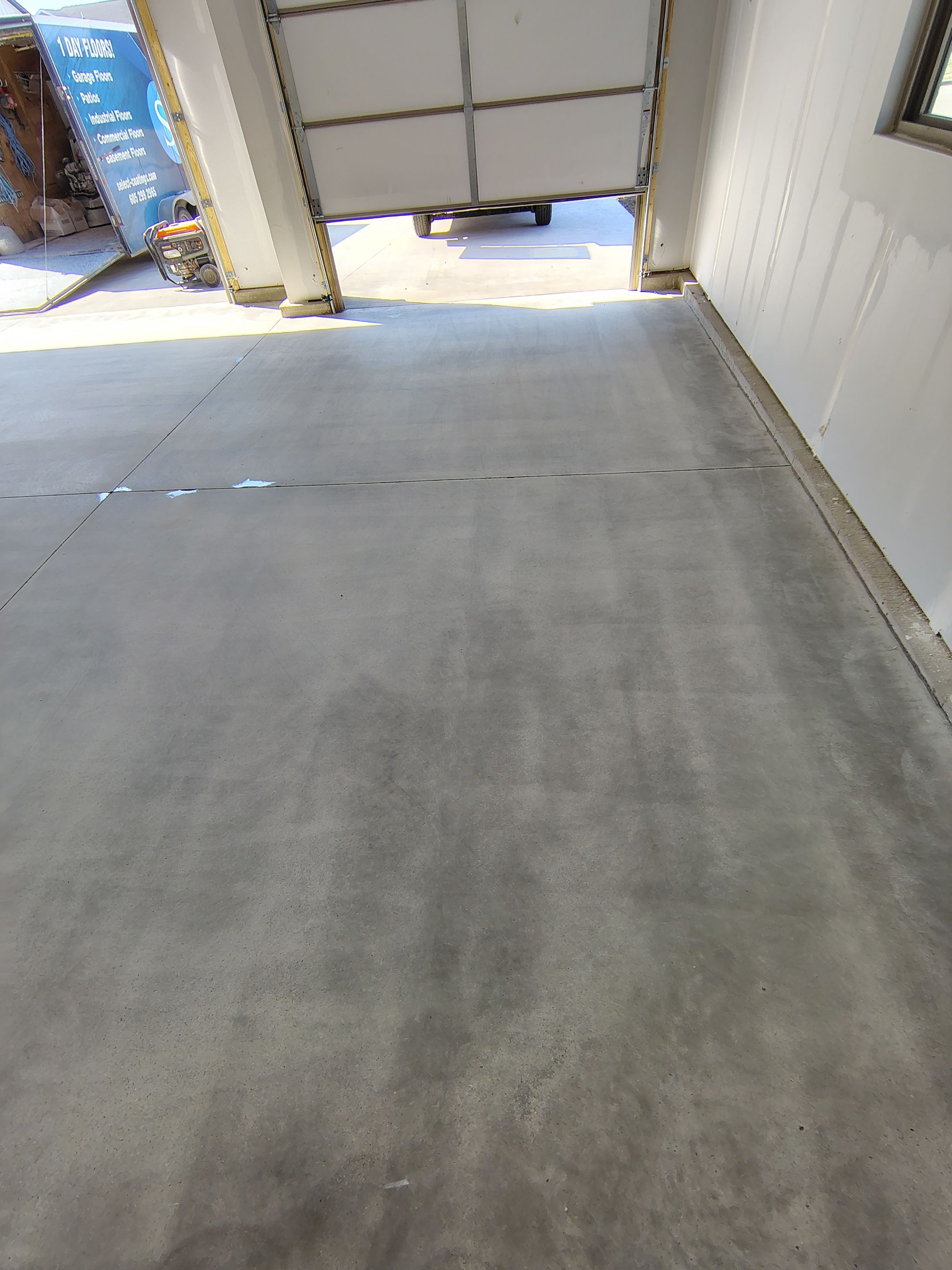 Speckled Epoxy Garage Floor Coating Installation in Sioux Falls by Select Painting, Coatings & Garage Cabinets