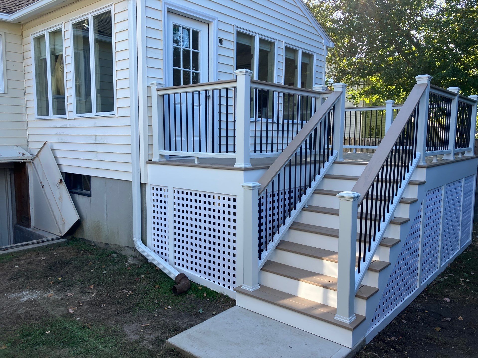 New Deck With Lattice enclosed bottom, Trex Lineage Carmel, Transcend cocktail rail.  by DiGiorgi Roofing and Siding Inc