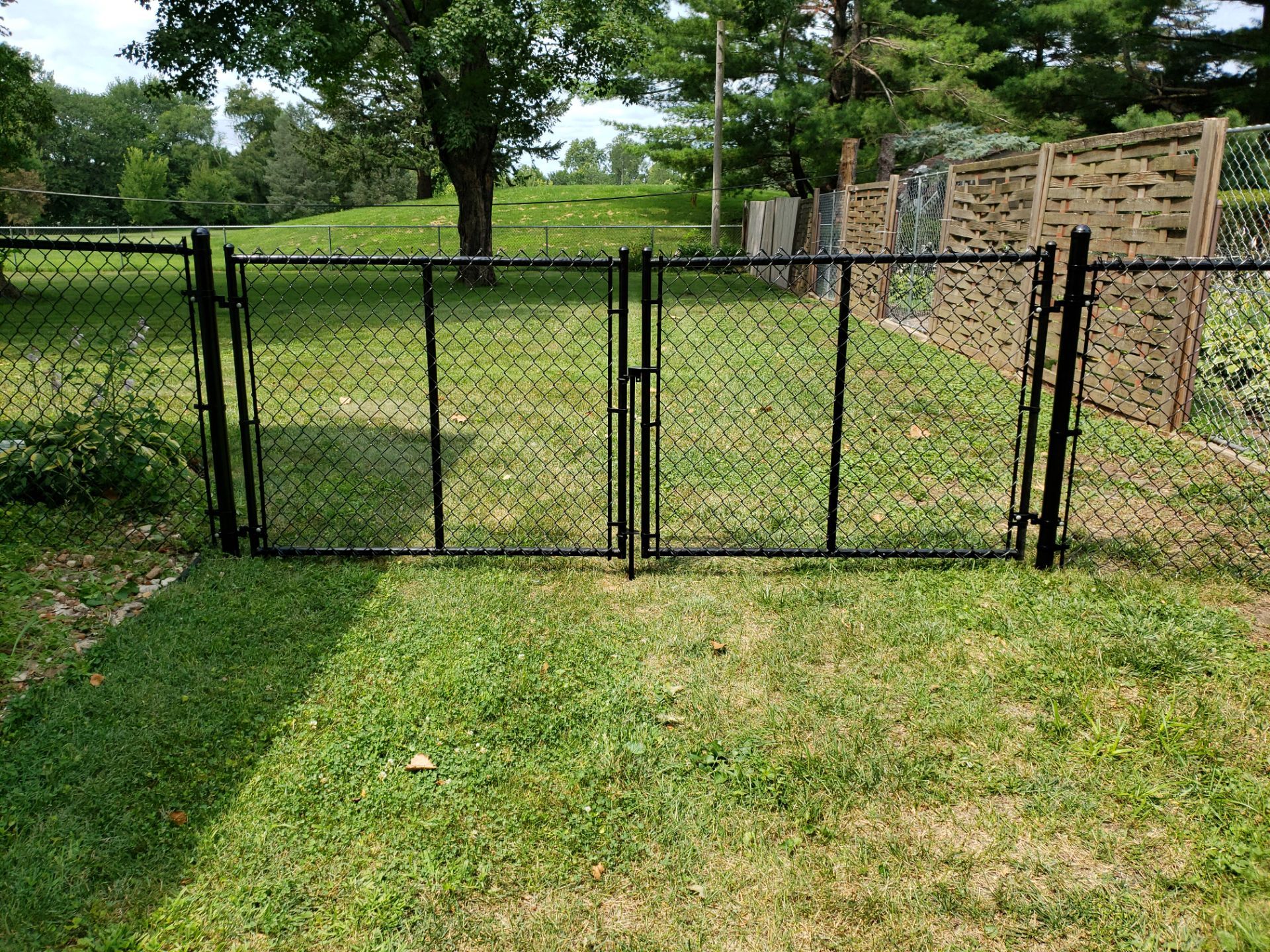Black Chain Link Fence Installation in Cedar Falls by Perfect Picket Fence and Stain