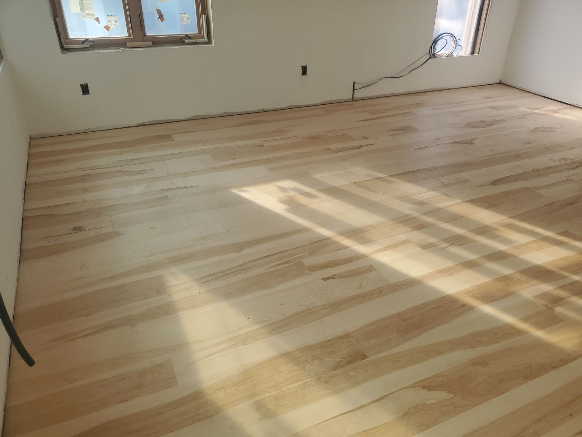 Full glue down Installation over radiant heat 7" Maple character grade by Ann Arbor Hardwoods 