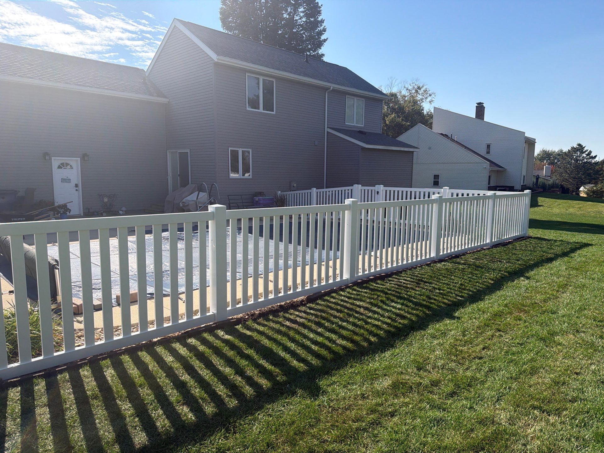 White Vinyl Picket Pool Fence Installation in Waterloo, Iowa by Perfect Picket Fence and Stain