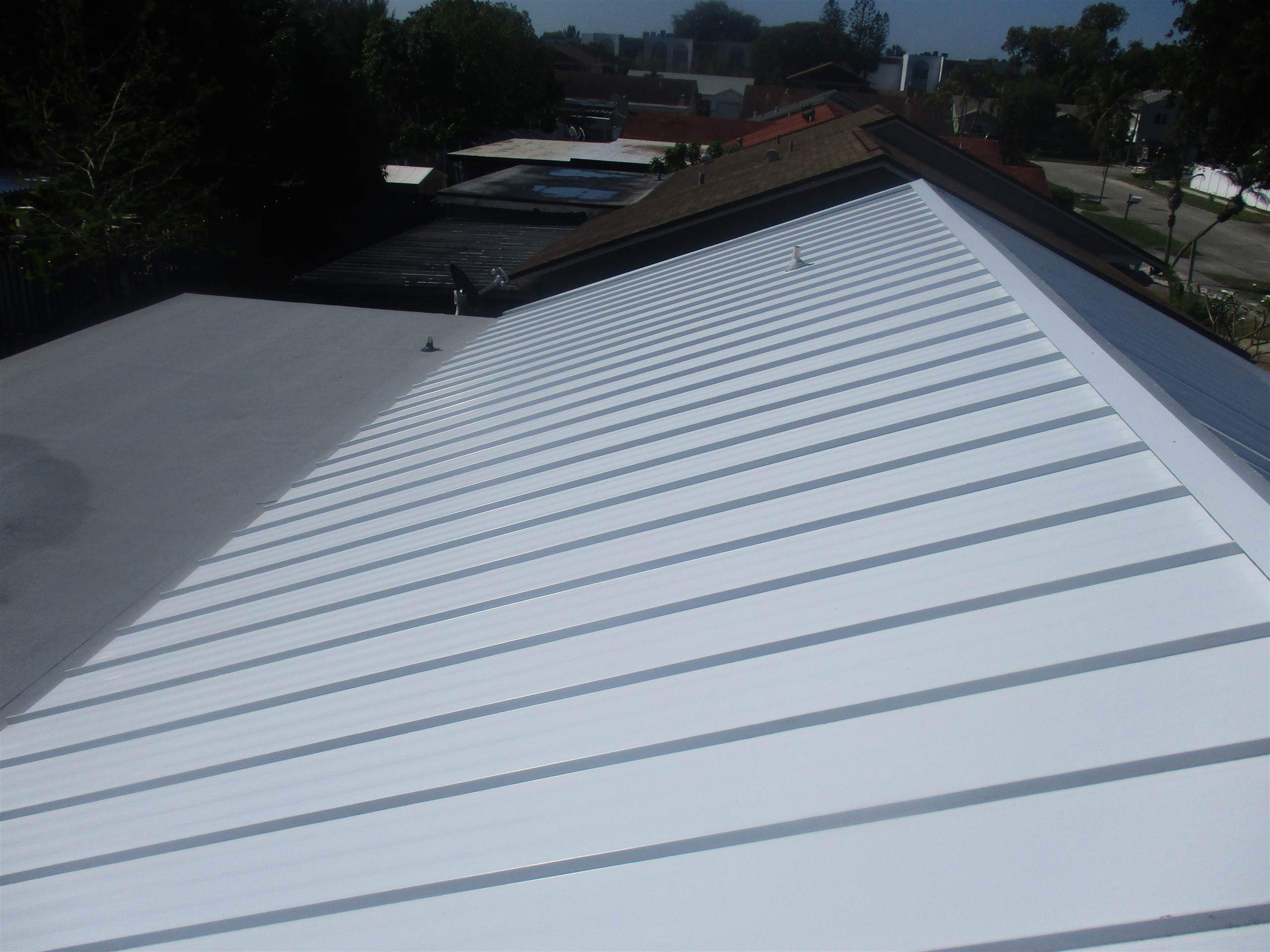 Standing Seam Metal & Flat Re-Roof using 1.5" Nail Strip 24ga Solar White Kynar Coated Standing Seam Metal Panels by Morton Roofing, Inc.