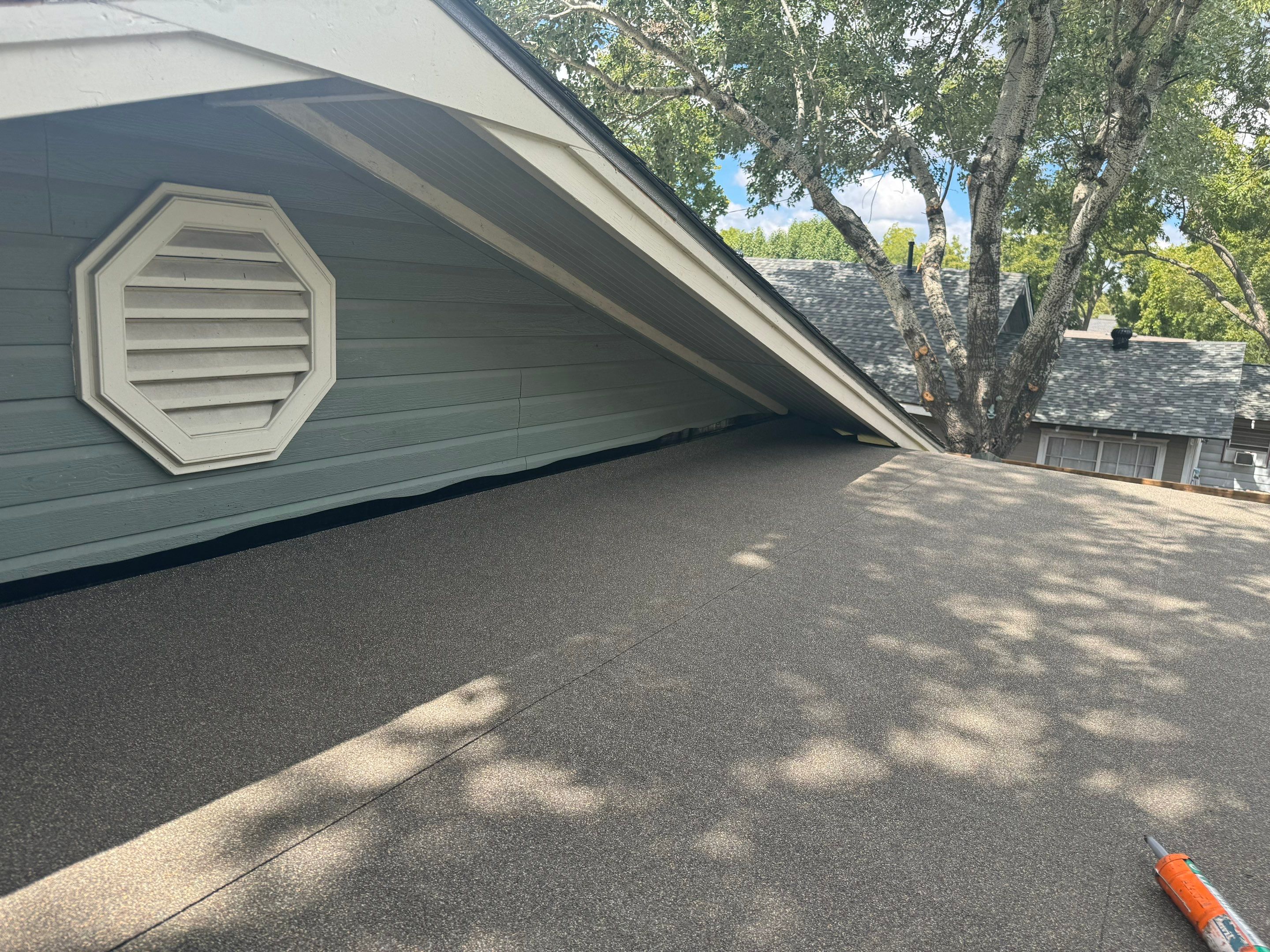 IKO Driftshake-Dark green siding house by Tejas Roofworks + Restoration
