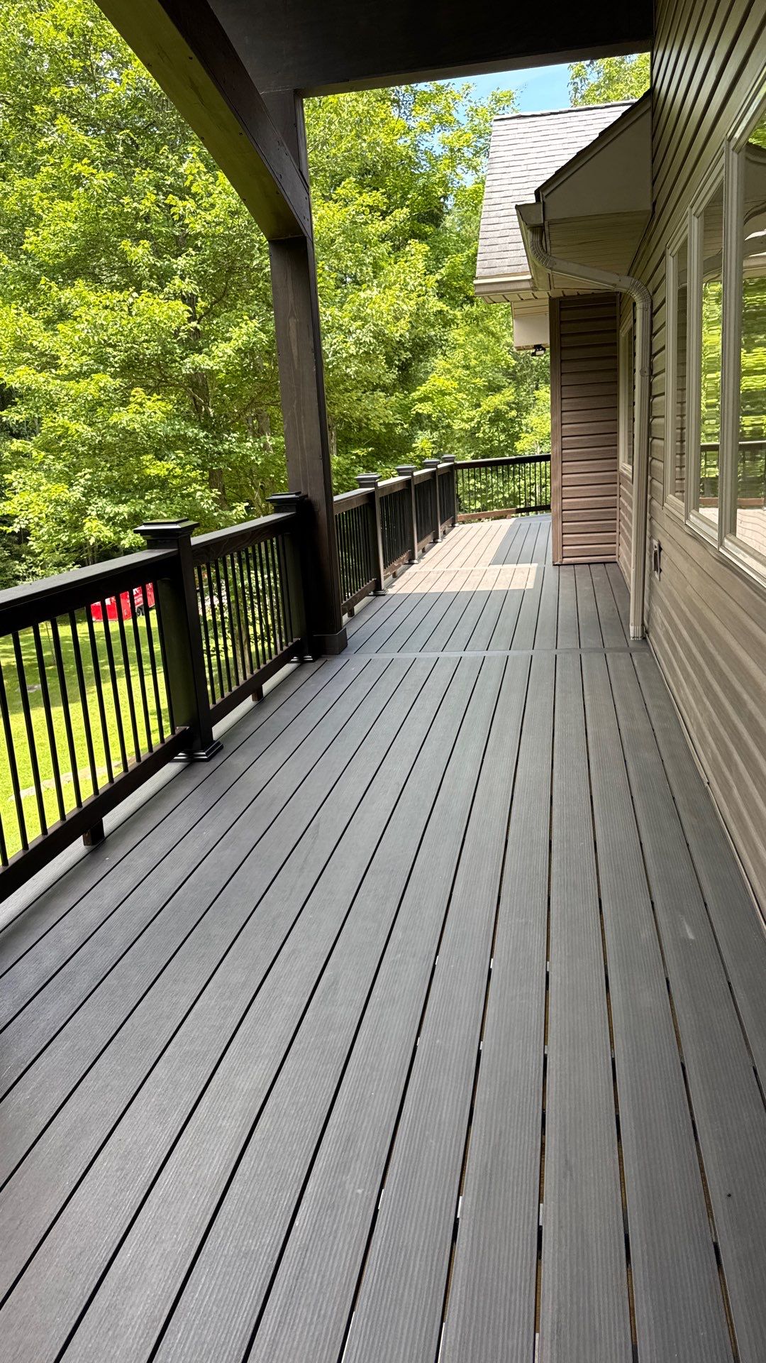Custom Composite Deck Construction with Stone Pillars in Fayetteville by Walnut Hollow Decks & Outdoor Living
