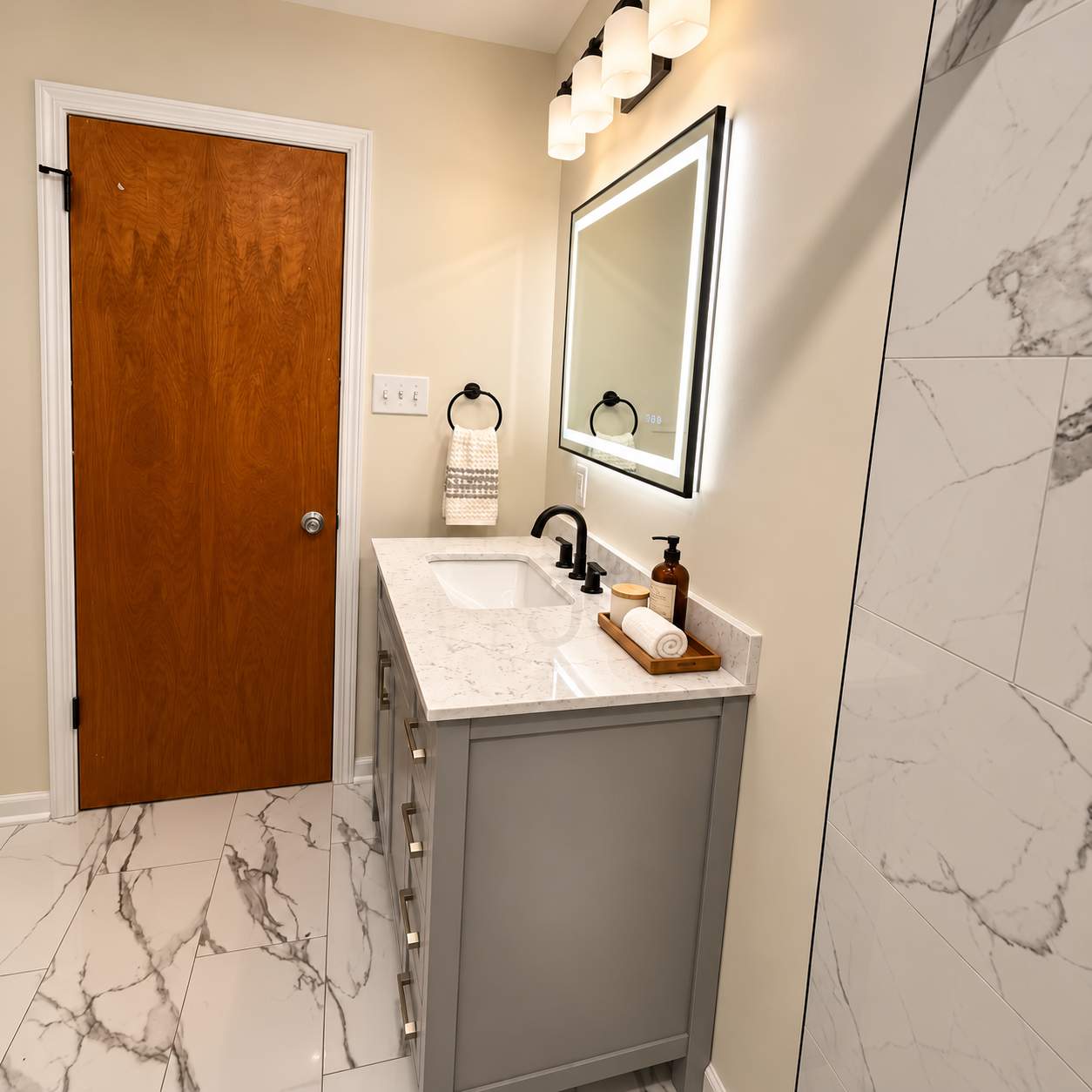 Modern Bathroom Remodel with Marble Tile & Matte Black Finishes by Remodel Now