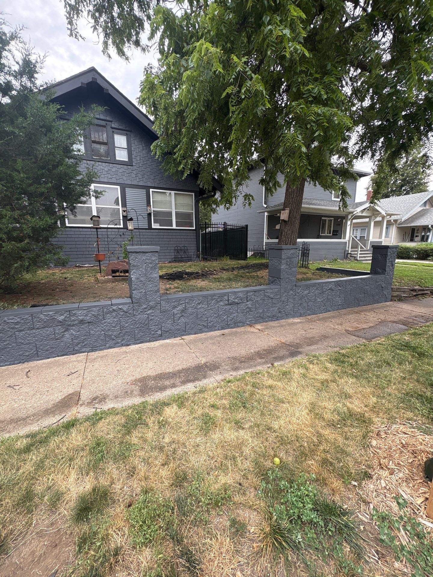 Exterior Masonry Painting for a Sioux Falls Retaining Wall by Select Painting, Coatings & Garage Cabinets