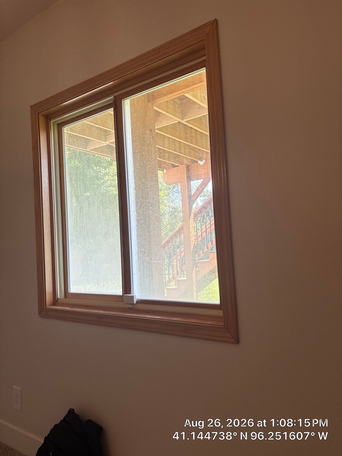 Residential Sliding Window Installation With Natural Wood Trim by CompanyCam Sales Demo