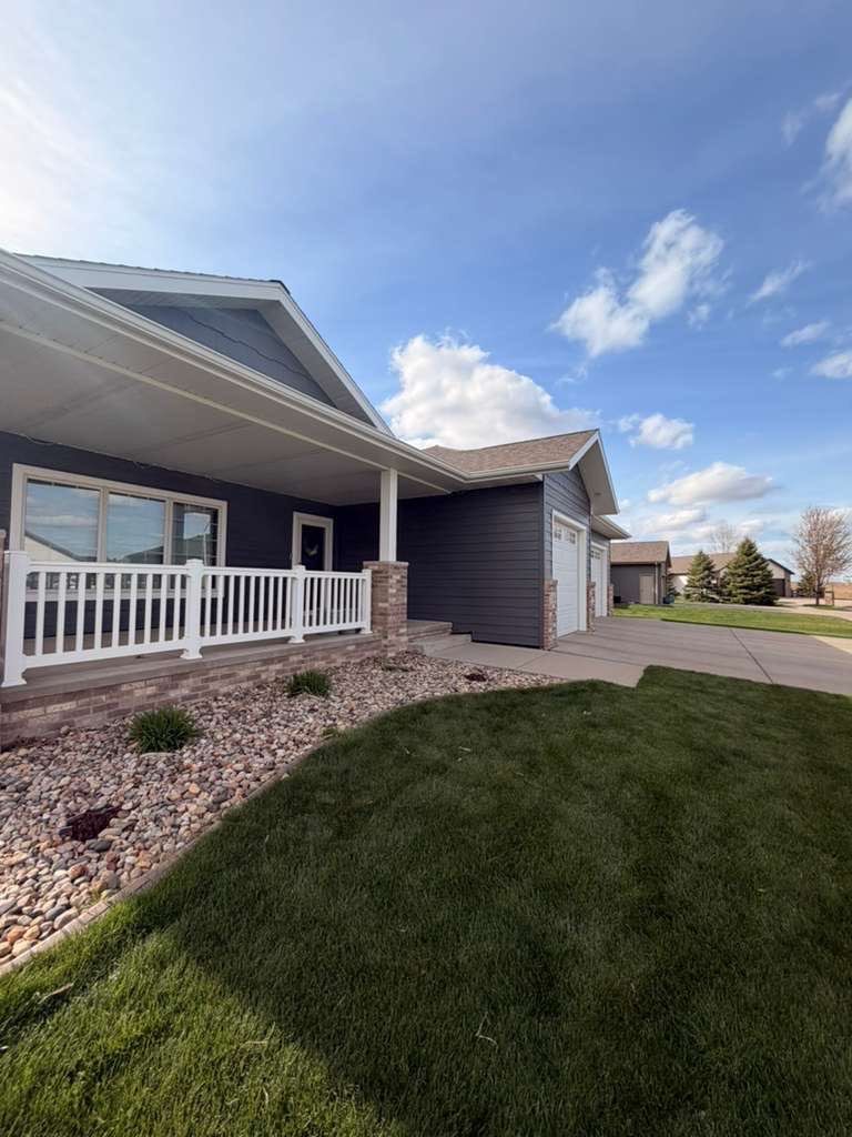 Madison Exterior Remodel with Dark Gray Siding and Stone Accents by Select Painting, Coatings & Garage Cabinets