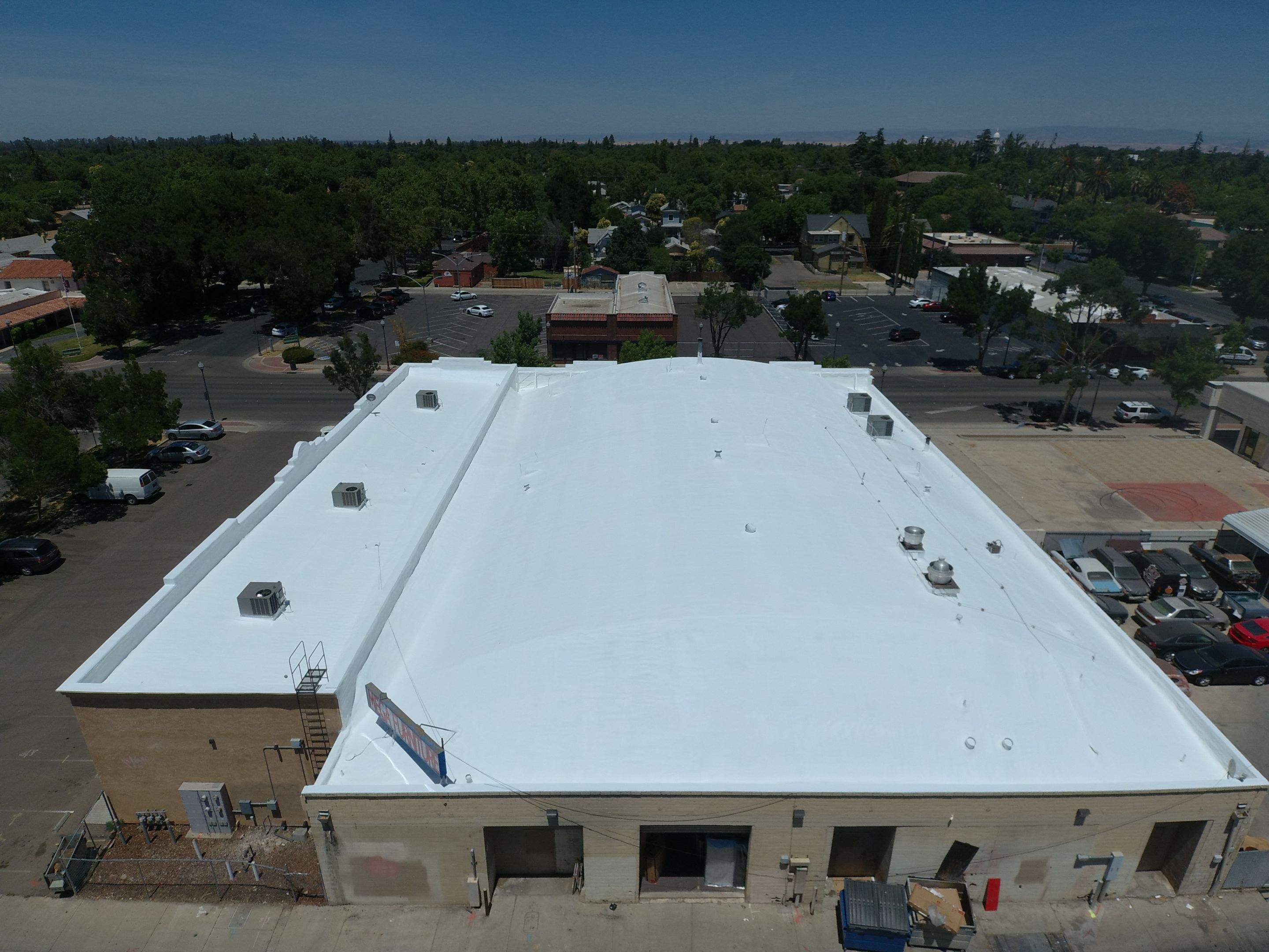 Spray foam and coatings using Conklin Benchmark/PUMA XL coatings and spray foam by Straight Edge Roofing Inc