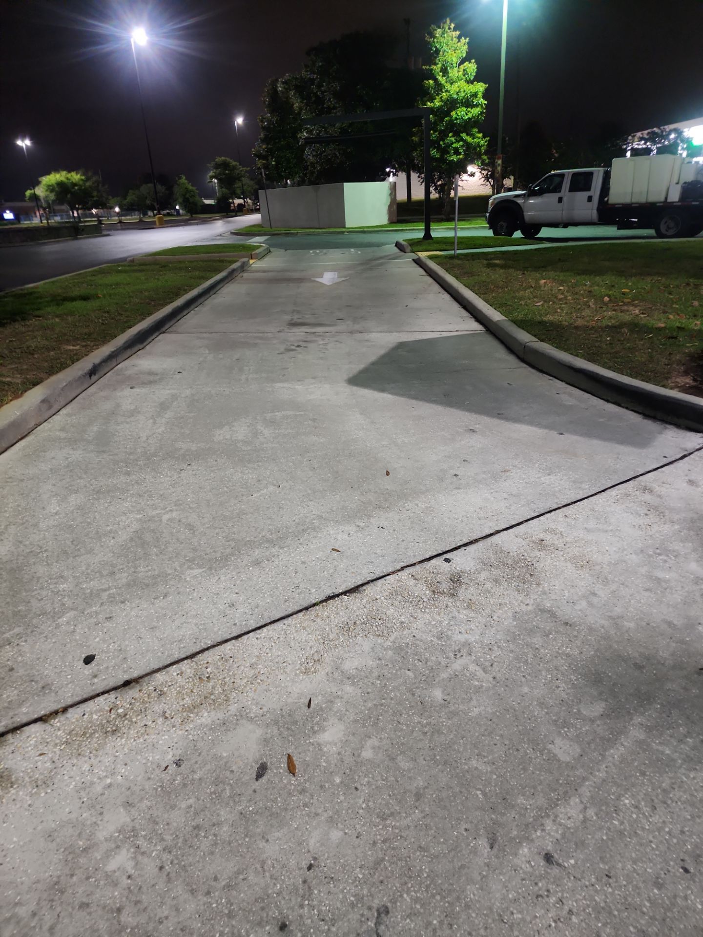 cleaned concrete sidewalk curb after pressure washing in Pensacola, Florida