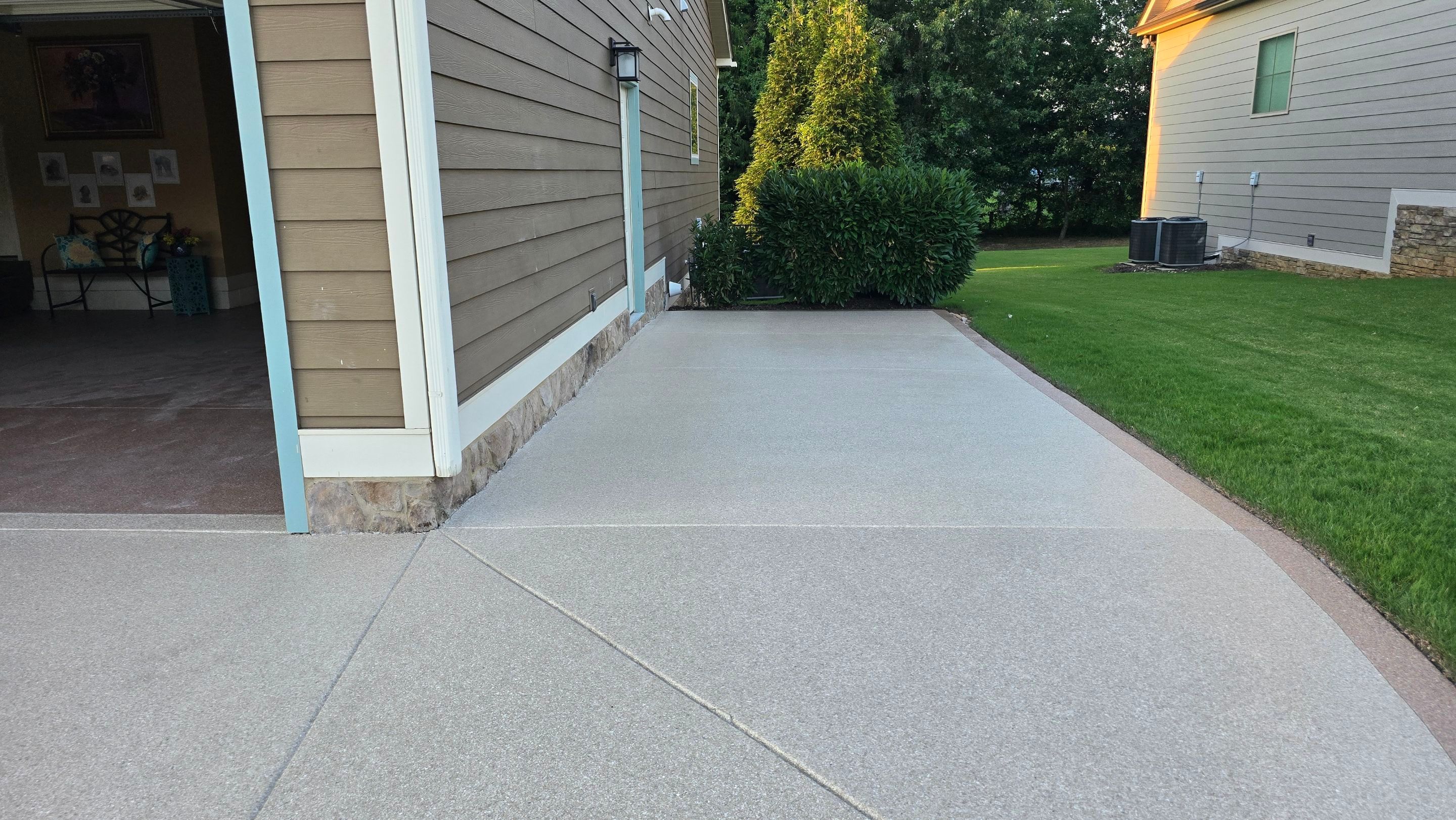 Driveway and sidewalk using Feldspar with the border done in Spilite by Elite Floor Solutions