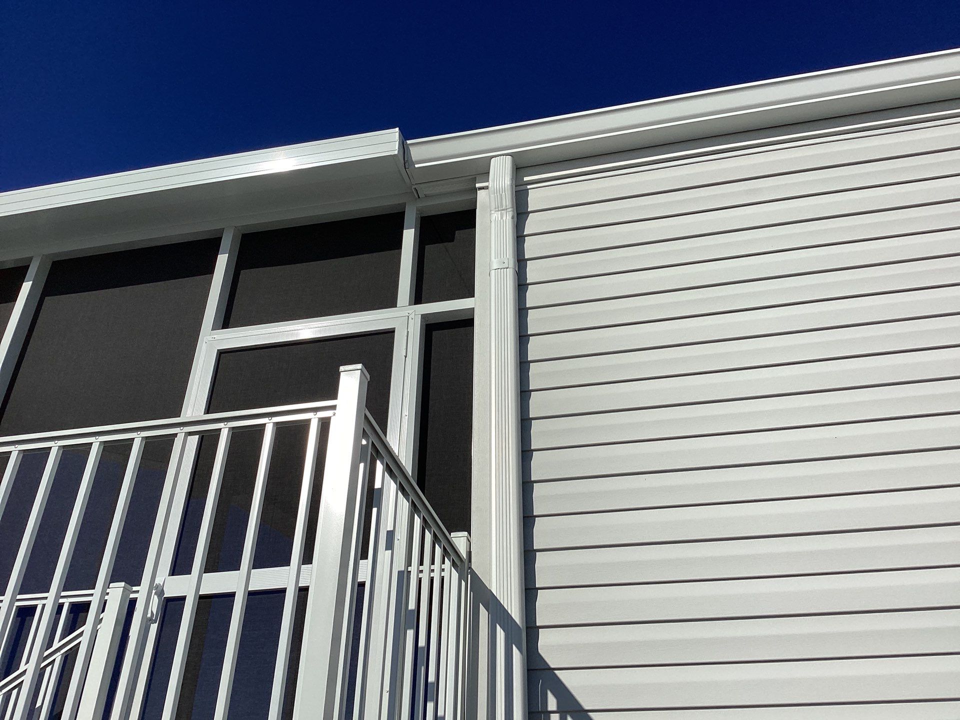 White Downspouts Installation in St. James City by Gutter Professors