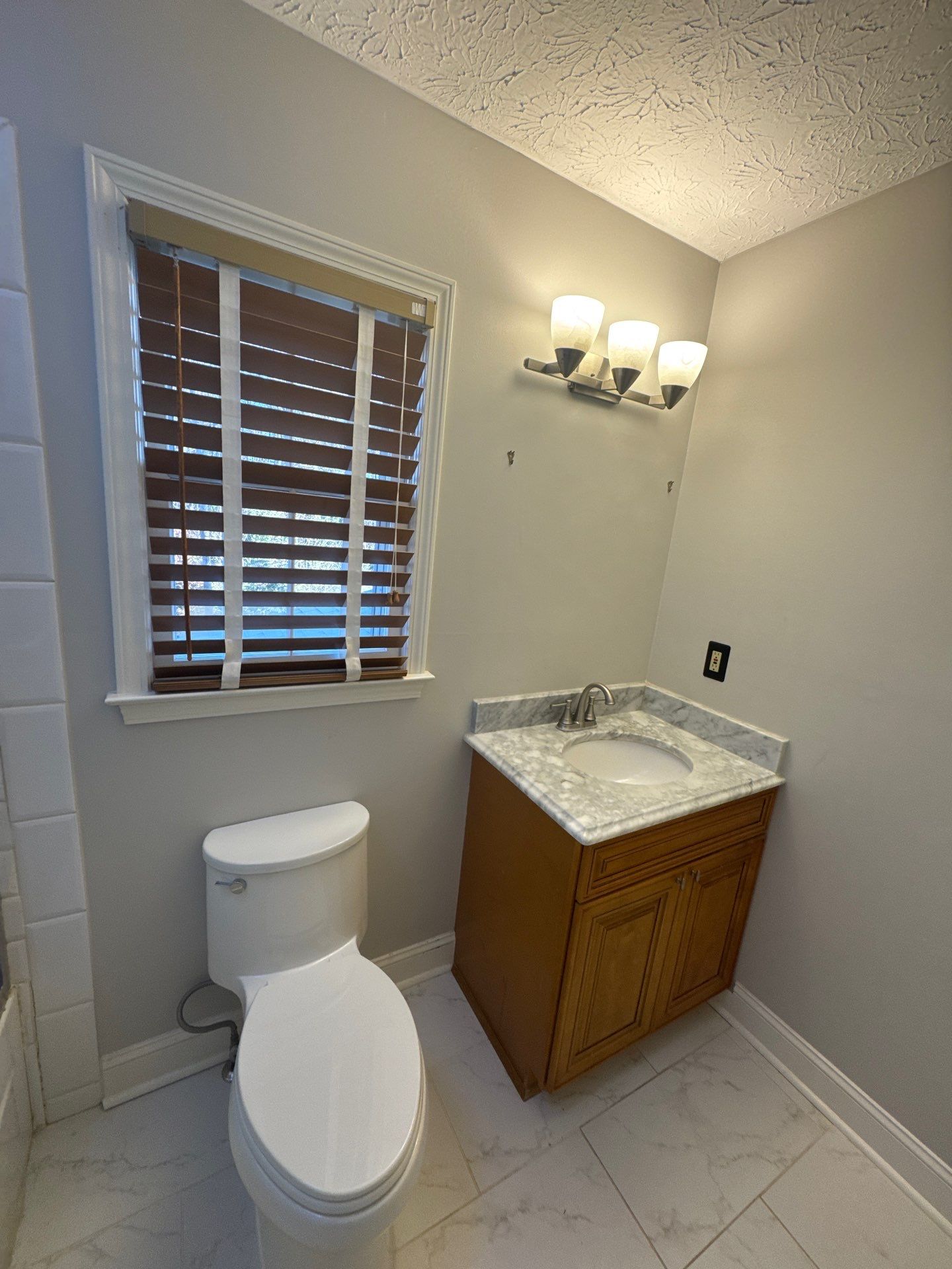 Smyrna Bathroom Remodel Featuring Sage Green Vanity and Hexagonal Tile by Swift Home Renovations