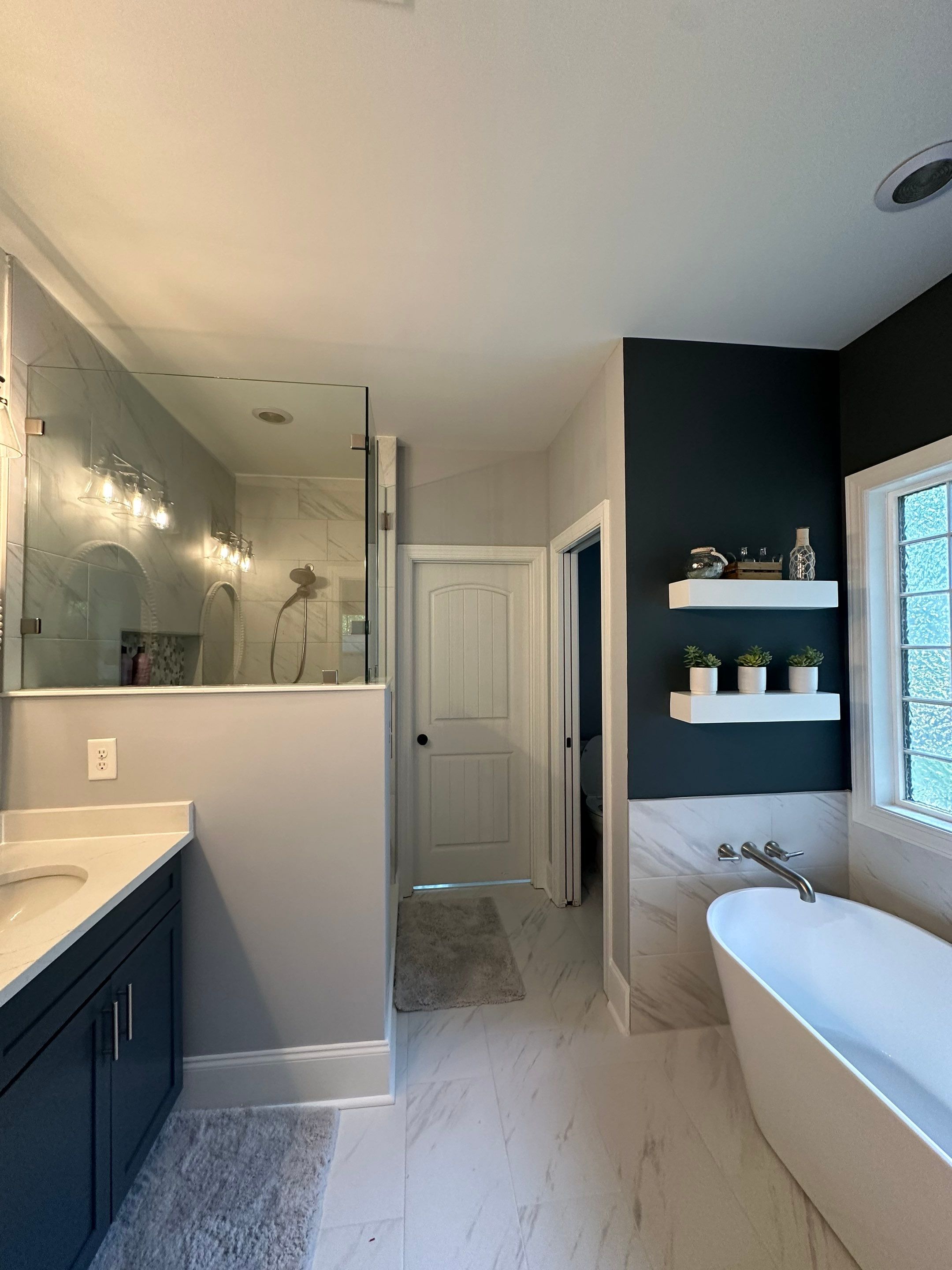 Bright Bathroom Remodel with Wall Removal, Stand Alone Tub and New Vanity by Footprints Floors of Coastal Carolina