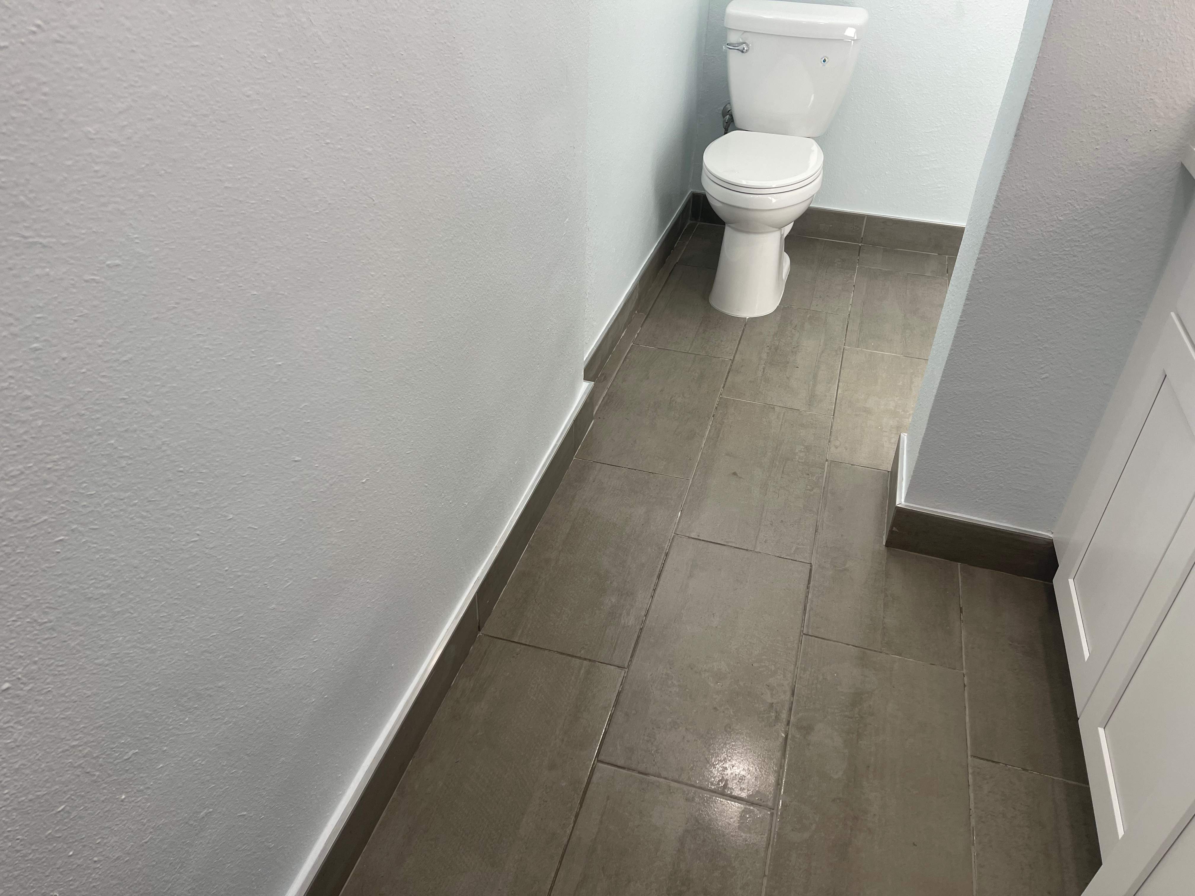 Complete Bathroom Remodel Featuring Marble Tile and Teal Herringbone Niche by Mena stone surfaces
