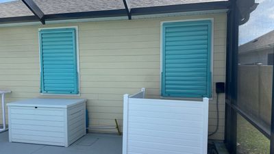 Hurricane Rated Bahama Shutters in Light Green