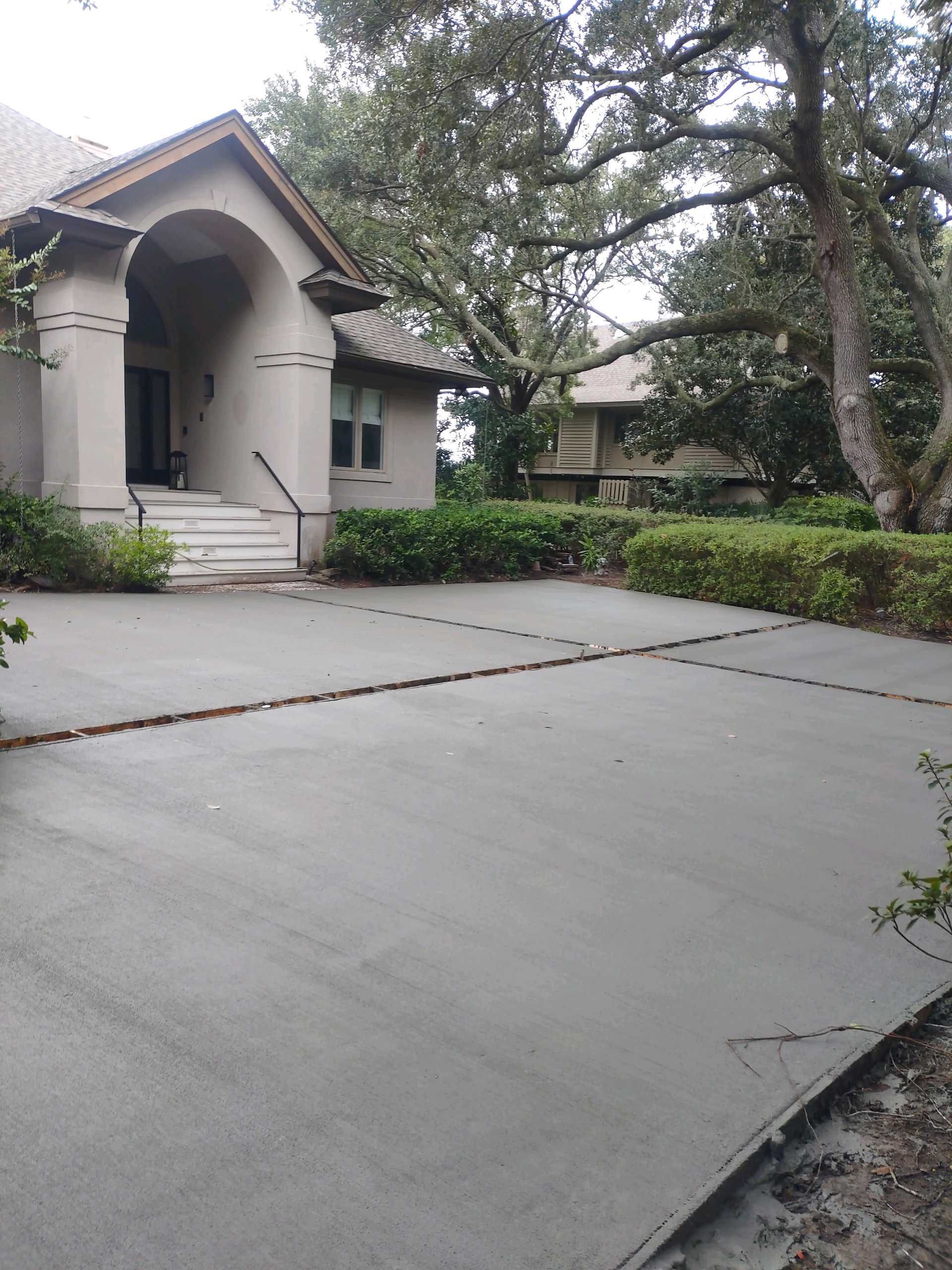 Custom Concrete Driveway with Decorative Paver Inlays in Hilton Head Island by Lowcountry Scapes, LLC