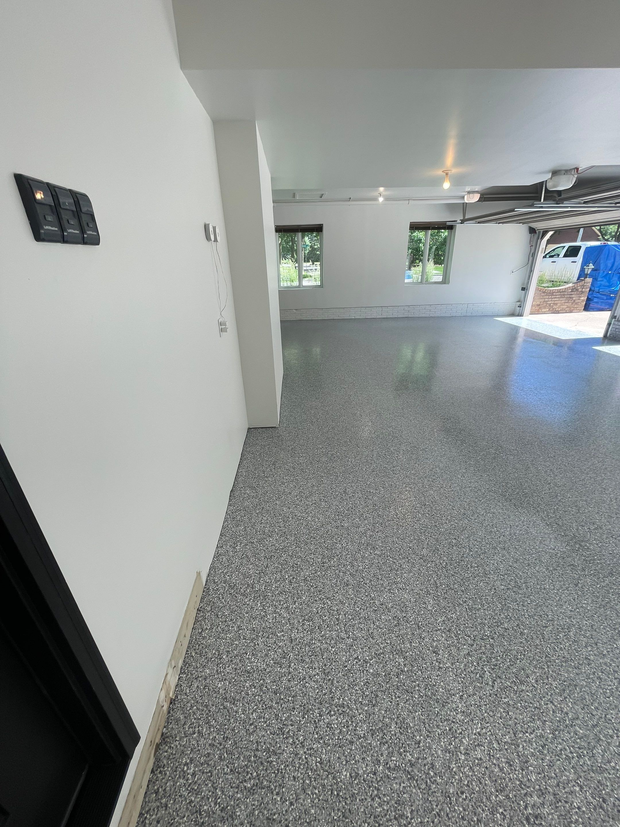 Gray Speckled Epoxy Garage Floor Coating in Sioux Falls by Select Painting, Coatings & Garage Cabinets
