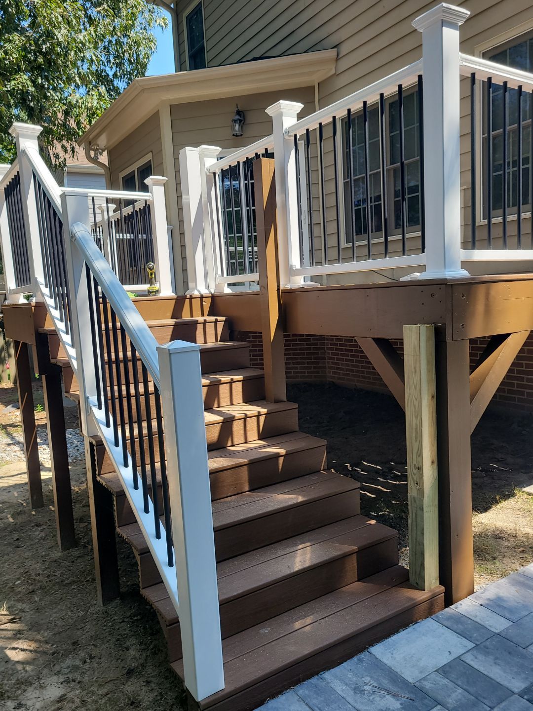 Fuquay-Varina Outdoor Upgrade – Composite Deck & Paved Landing by Elite Remodeling and Design LLC