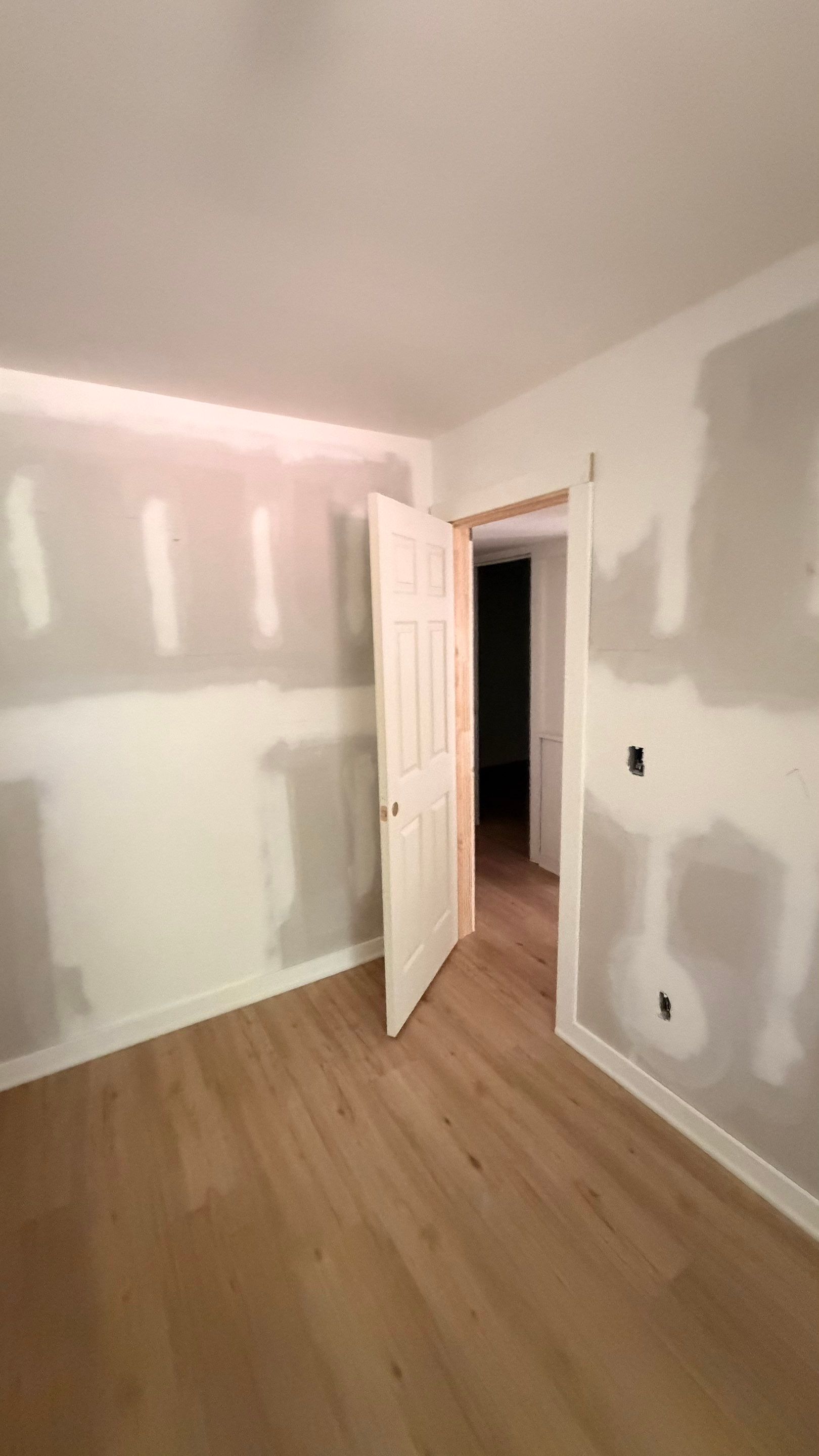 Basement Remodeling with Wood-Look Flooring and Custom Wainscoting in Dunwoody by Swift Home Renovations