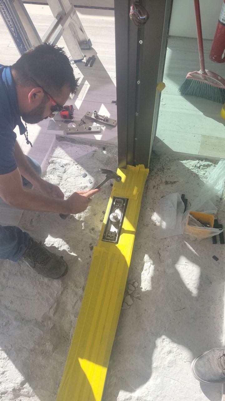 Custom Material Pivot Door installation by Impact Precious Wood Inc.