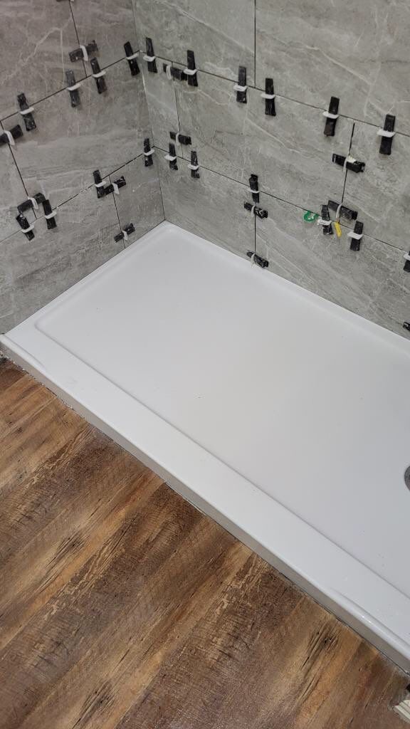 Bathroom Remodel using Tile  by SLM General Contractors & Roofing