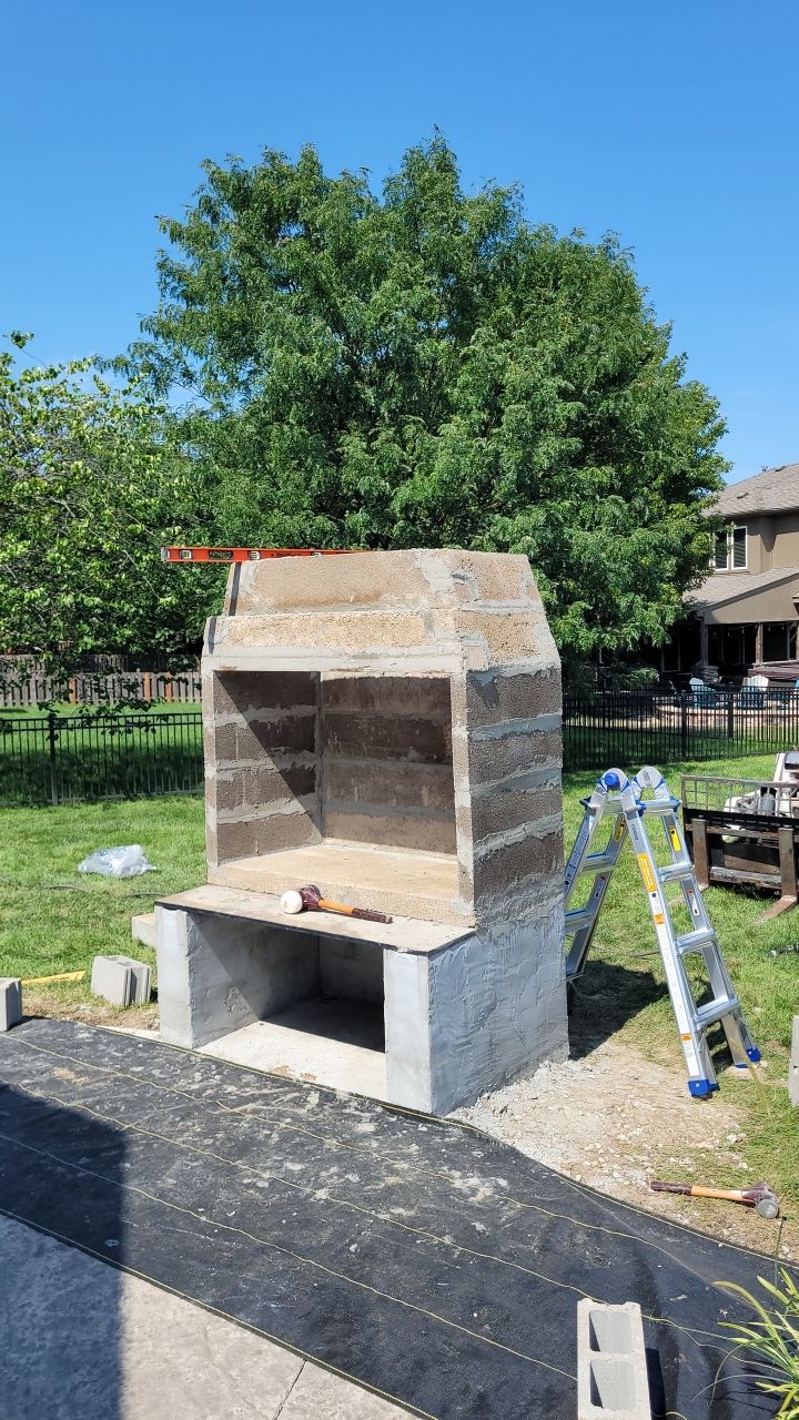 Back Yard Fireplace and Landscape by LAND ESCAPES LLC