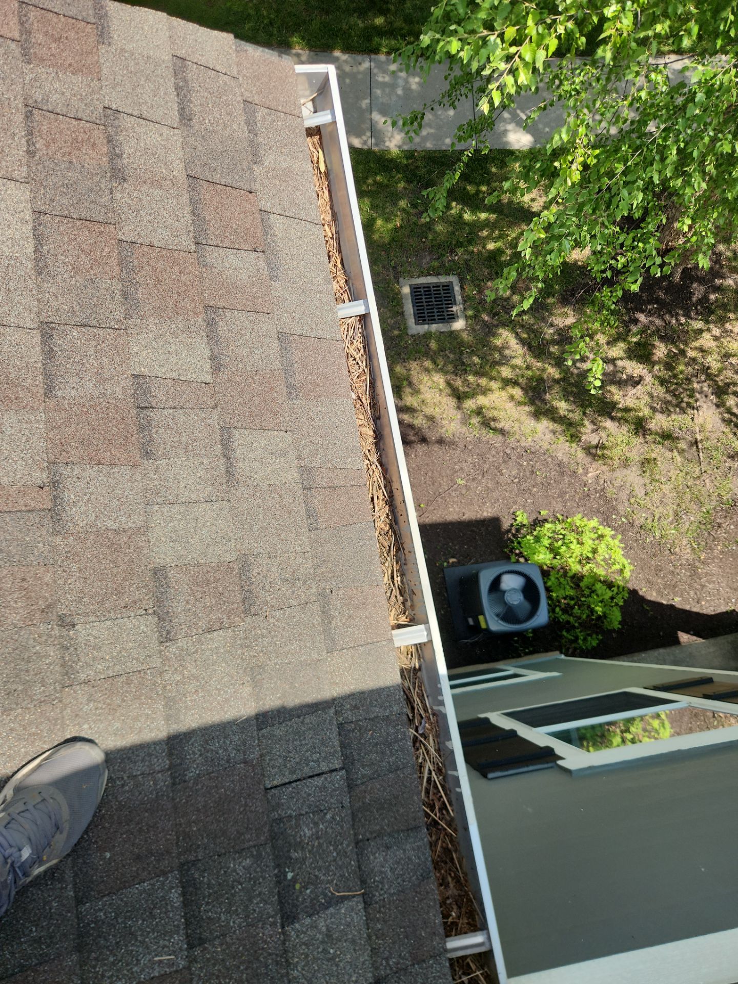 Commercial gutter cleaning Columbia, MO before photo with filled gutters