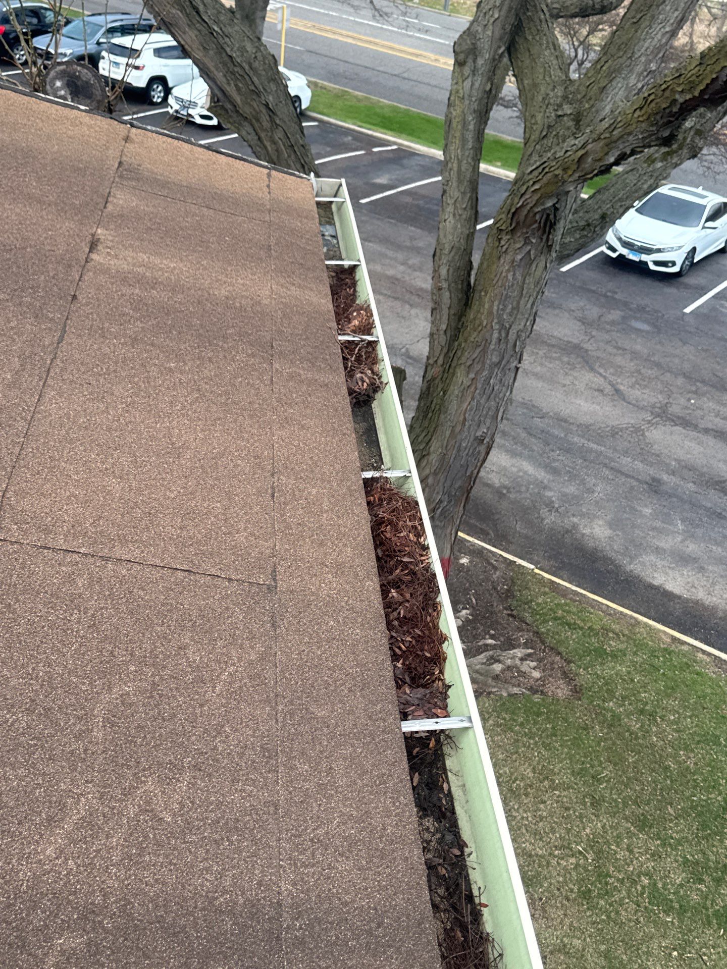 Commercial gutter cleaning Naperville & Aurora, IL before photo with filled gutters