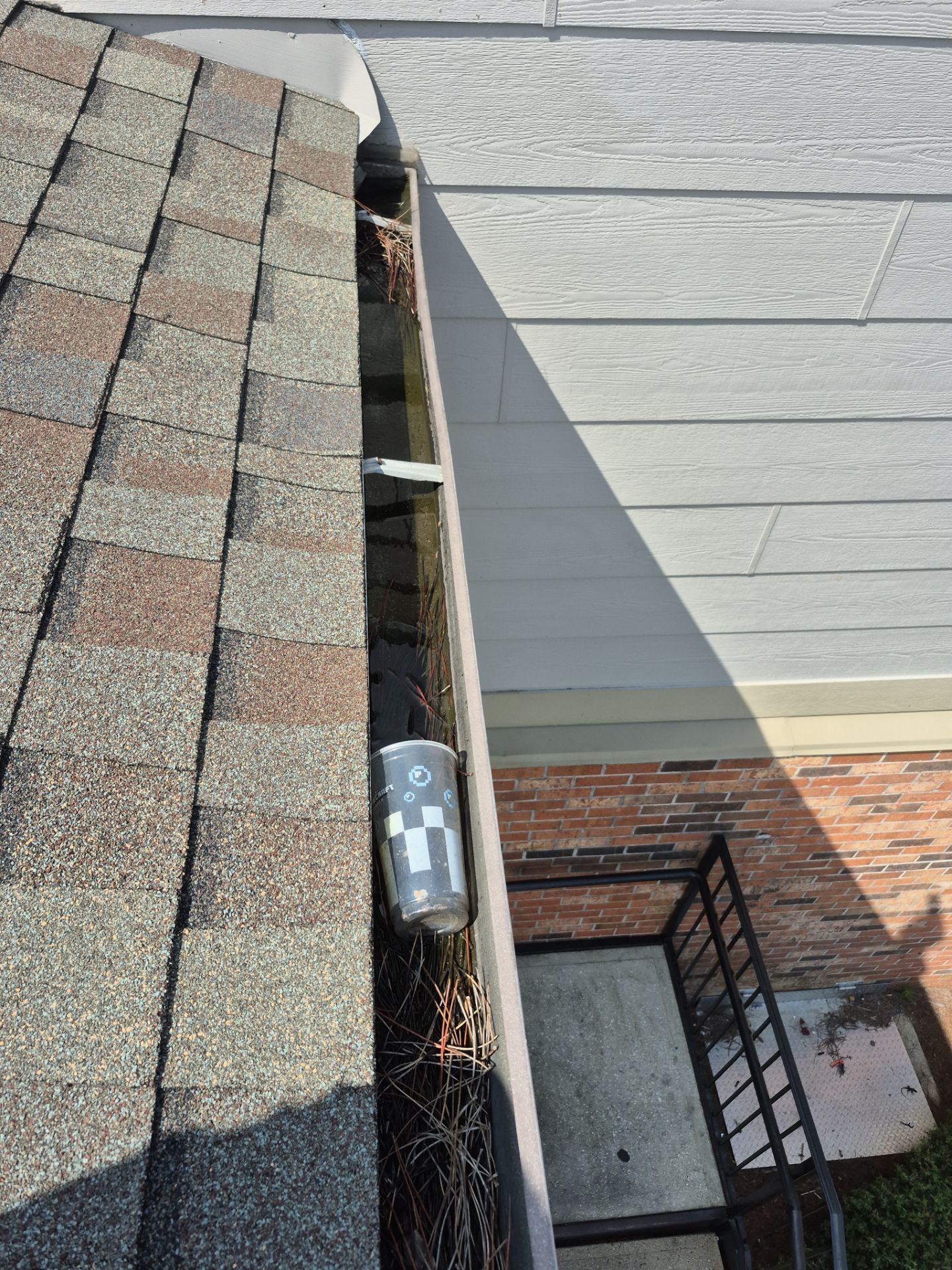 Commercial gutter cleaning Panama City, FL before photo with filled gutters