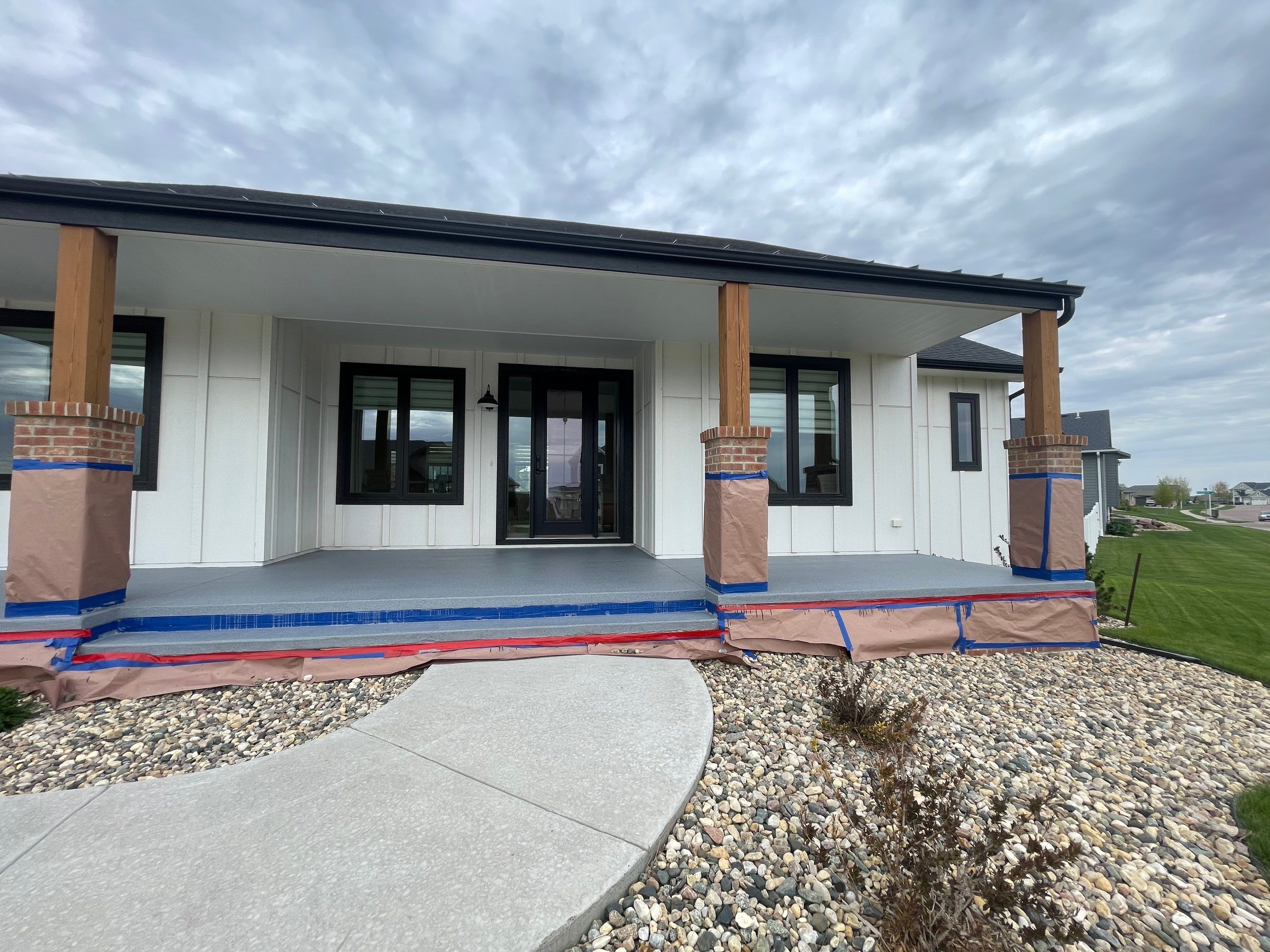 Grey Speckled Concrete Porch Coating for Sioux Falls Home by Select Painting, Coatings & Garage Cabinets