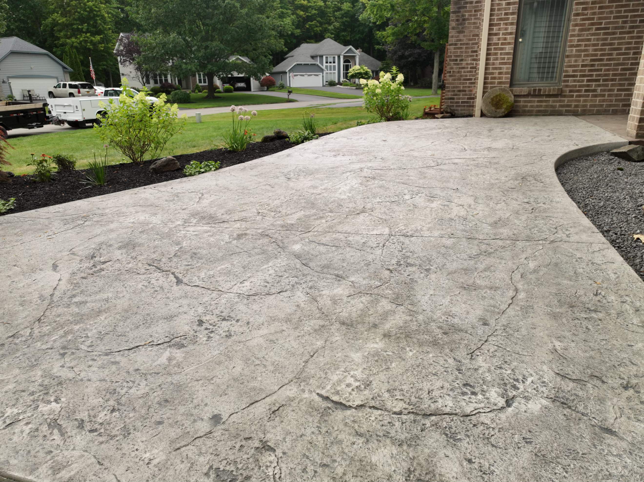 Heavy stone textured stamped concrete patio  by NG Masonry & Construction LLC