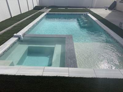 Pool and spa modern shape turf around pool