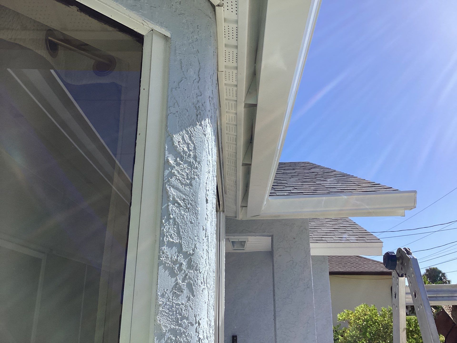New White Seamless Gutters with Downspouts and Splash Guards in Cape Coral FL by Gutter Professors