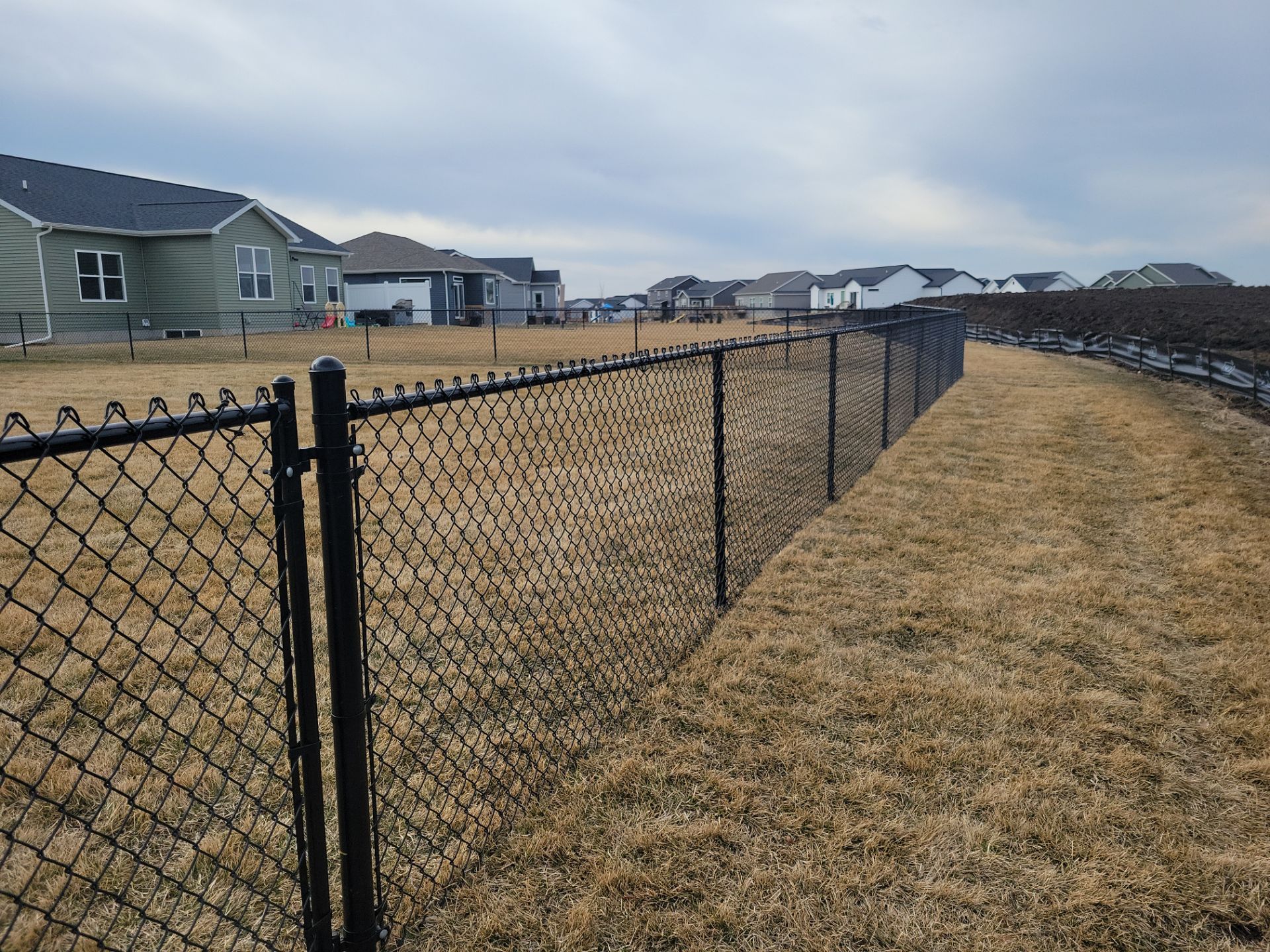 Black Chain Link Fence and Gate Installation in Cedar Falls by Perfect Picket Fence and Stain