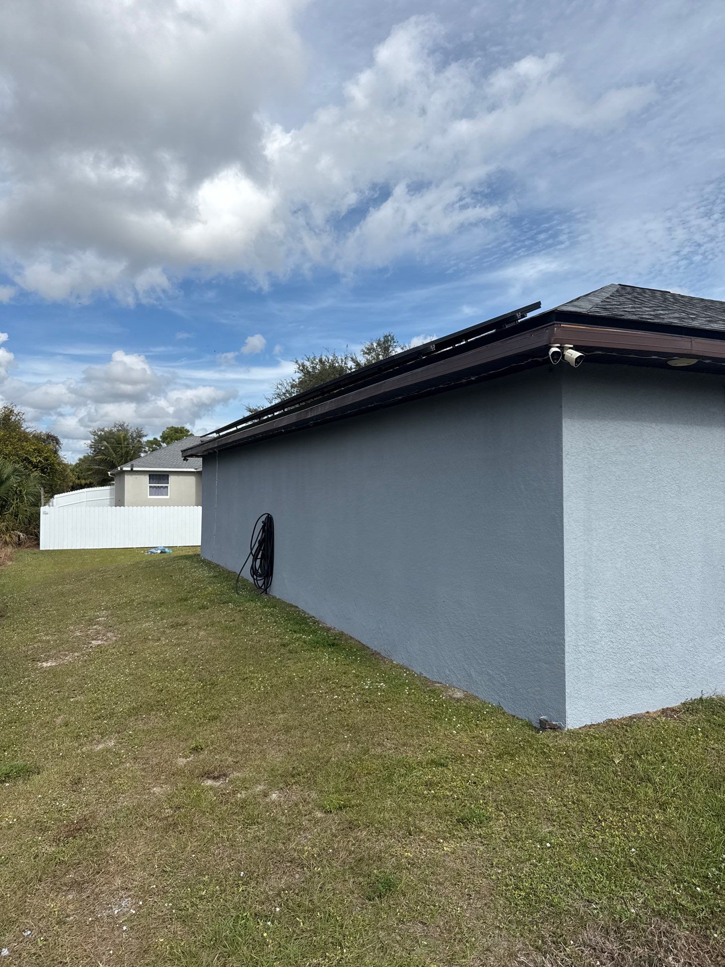 Black Seamless Gutters & Soffit/Fascia in Lehigh Acres FL by Gutter Professors