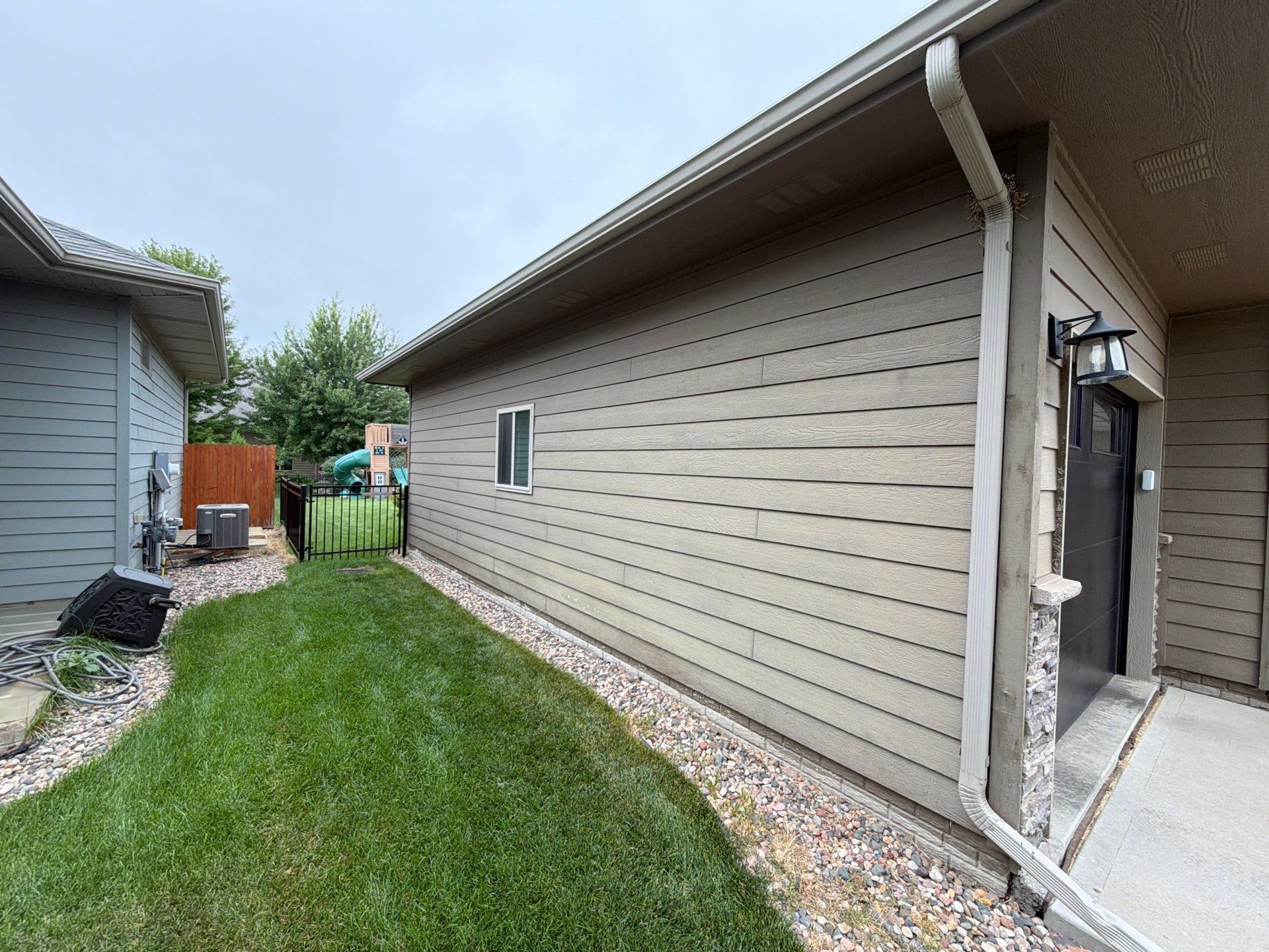 Full Exterior Siding Repaint for Sioux Falls Home and Garage by Select Painting, Coatings & Garage Cabinets