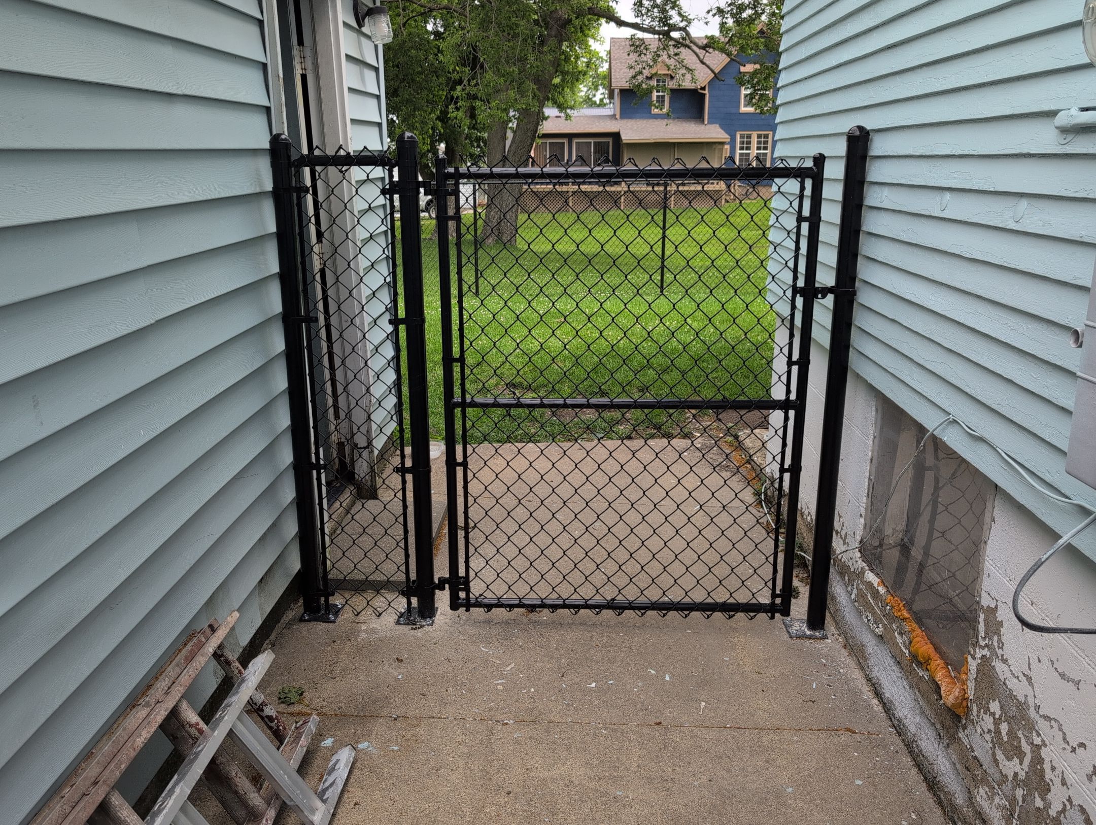 Black Vinyl Coated Chain Link Fence Installation in Independence by Perfect Picket Fence and Stain
