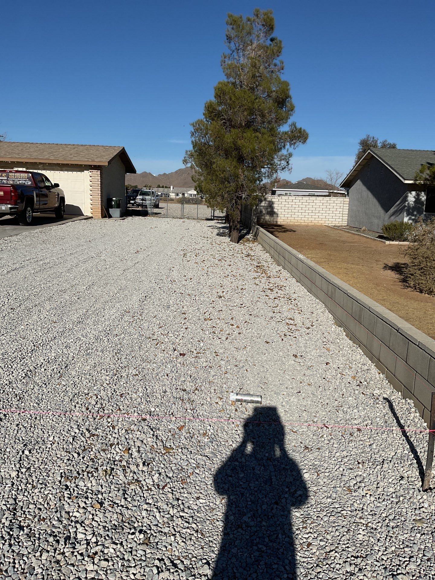 Sleek chain link fence installation with a solar motorized gate by Fence Guys Inc.
