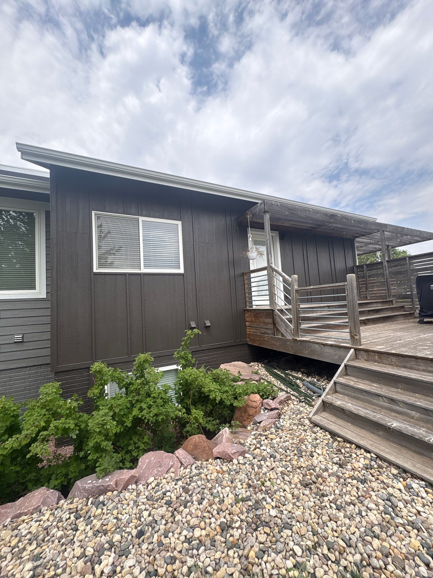 Modern Exterior Transformation Featuring Dark Board and Batten Siding in Sioux Falls by Select Painting, Coatings & Garage Cabinets