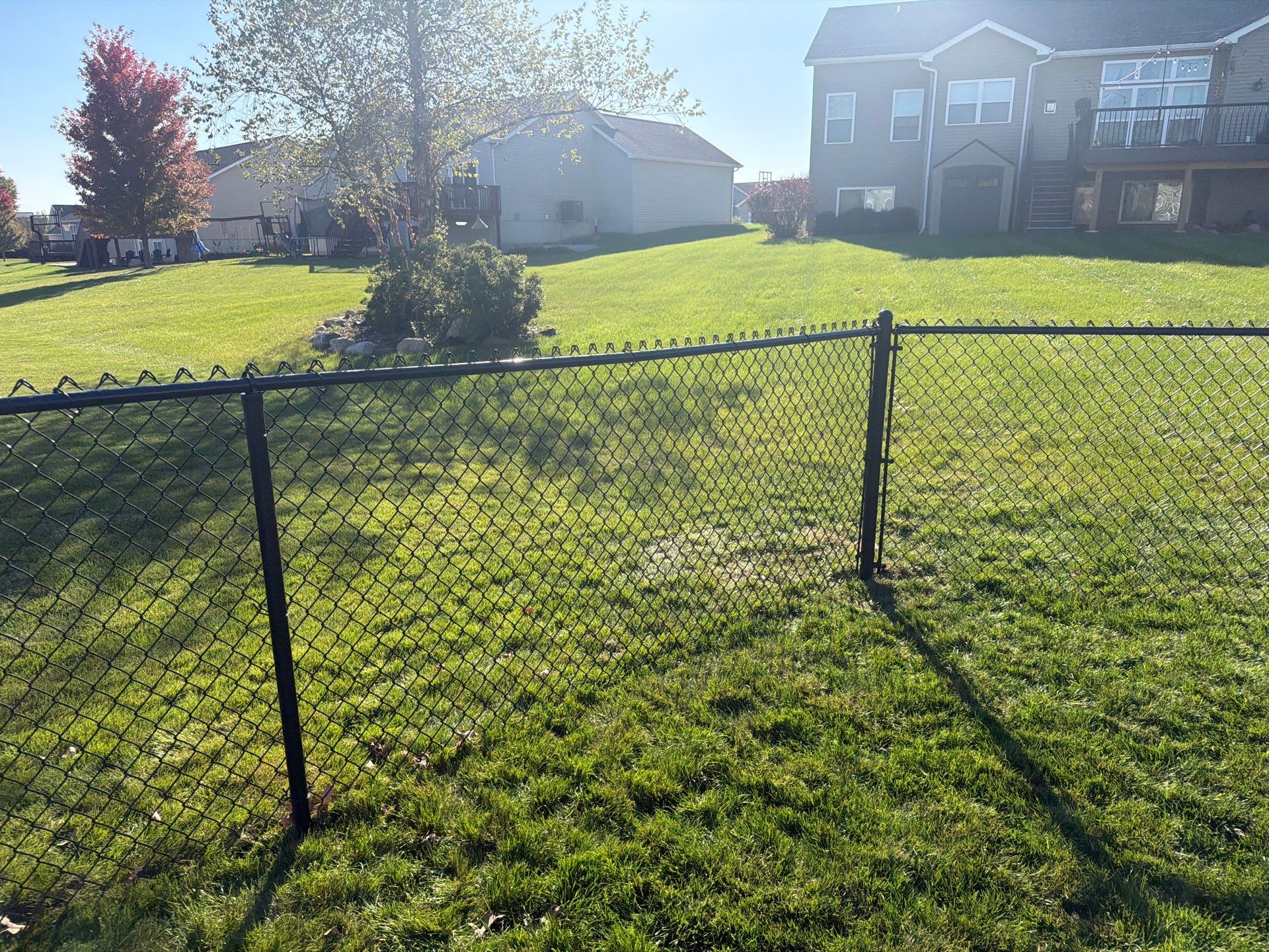 Black Vinyl-Coated Chain Link Fence Installation in Cedar Falls by Perfect Picket Fence and Stain