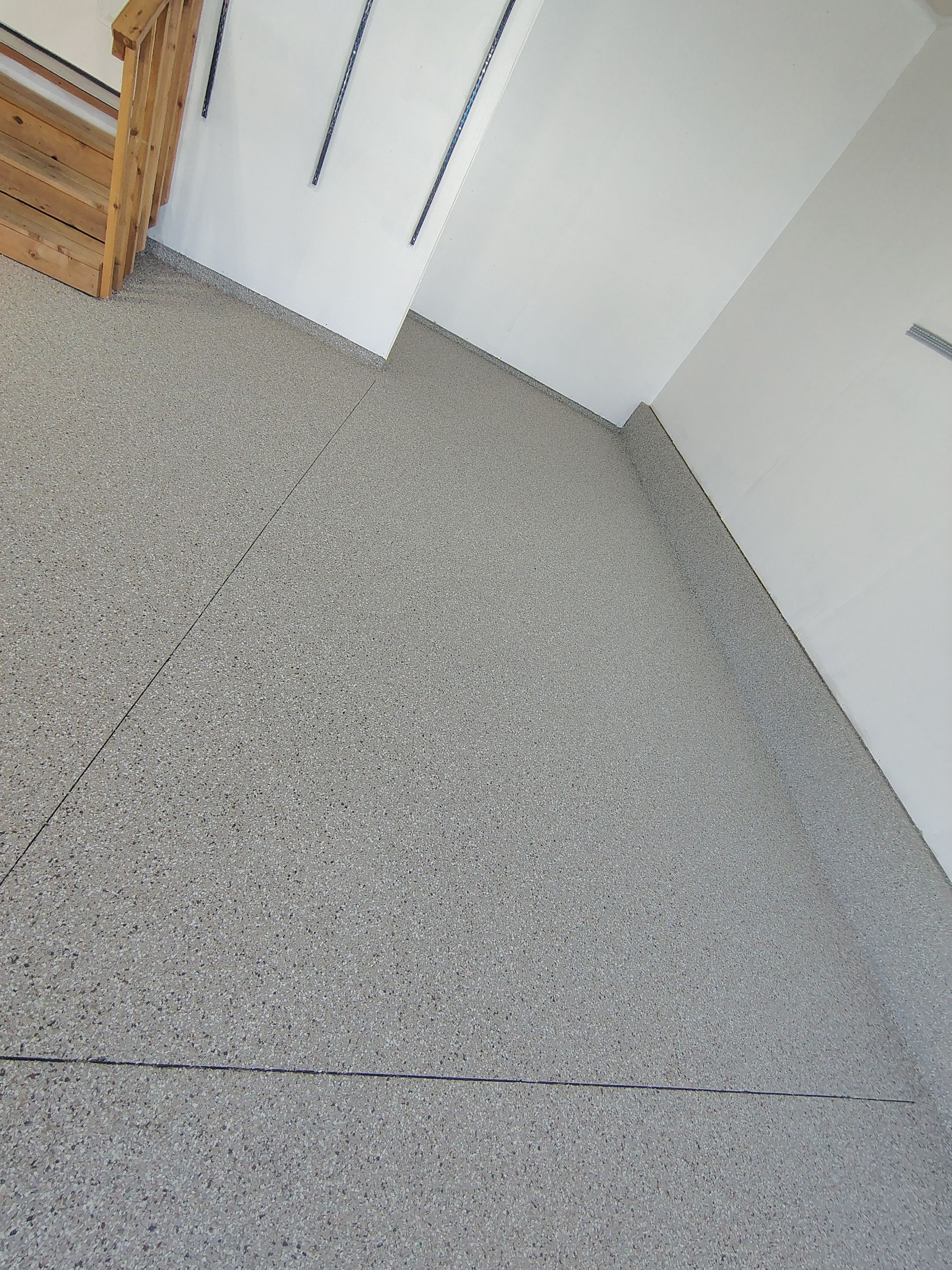 Sioux Falls Garage Floor Transformation With Gray Speckled Epoxy Coating by Select Painting, Coatings & Garage Cabinets