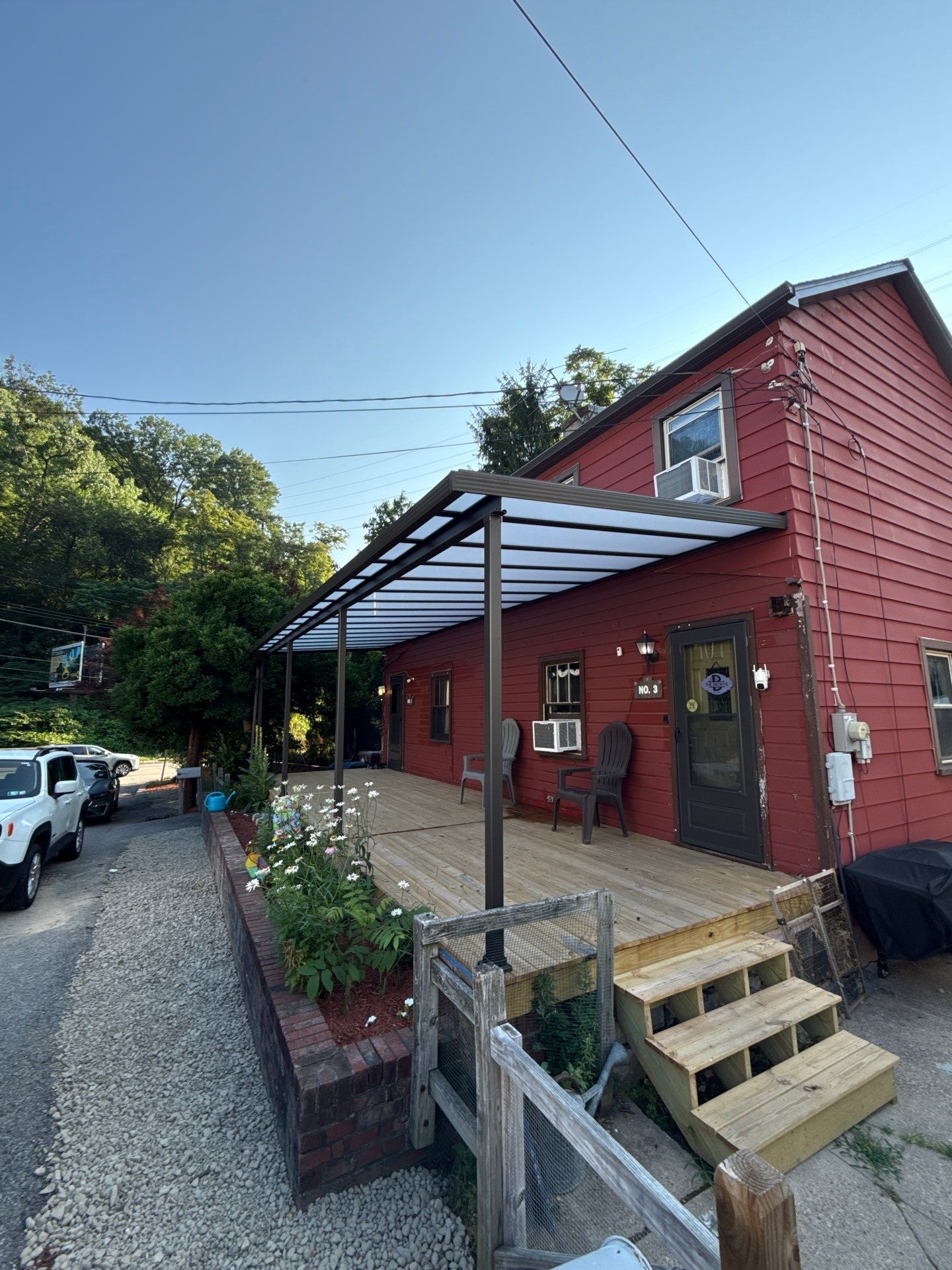 Roof sunspace deck  by Cousins Roofing Siding & Decks