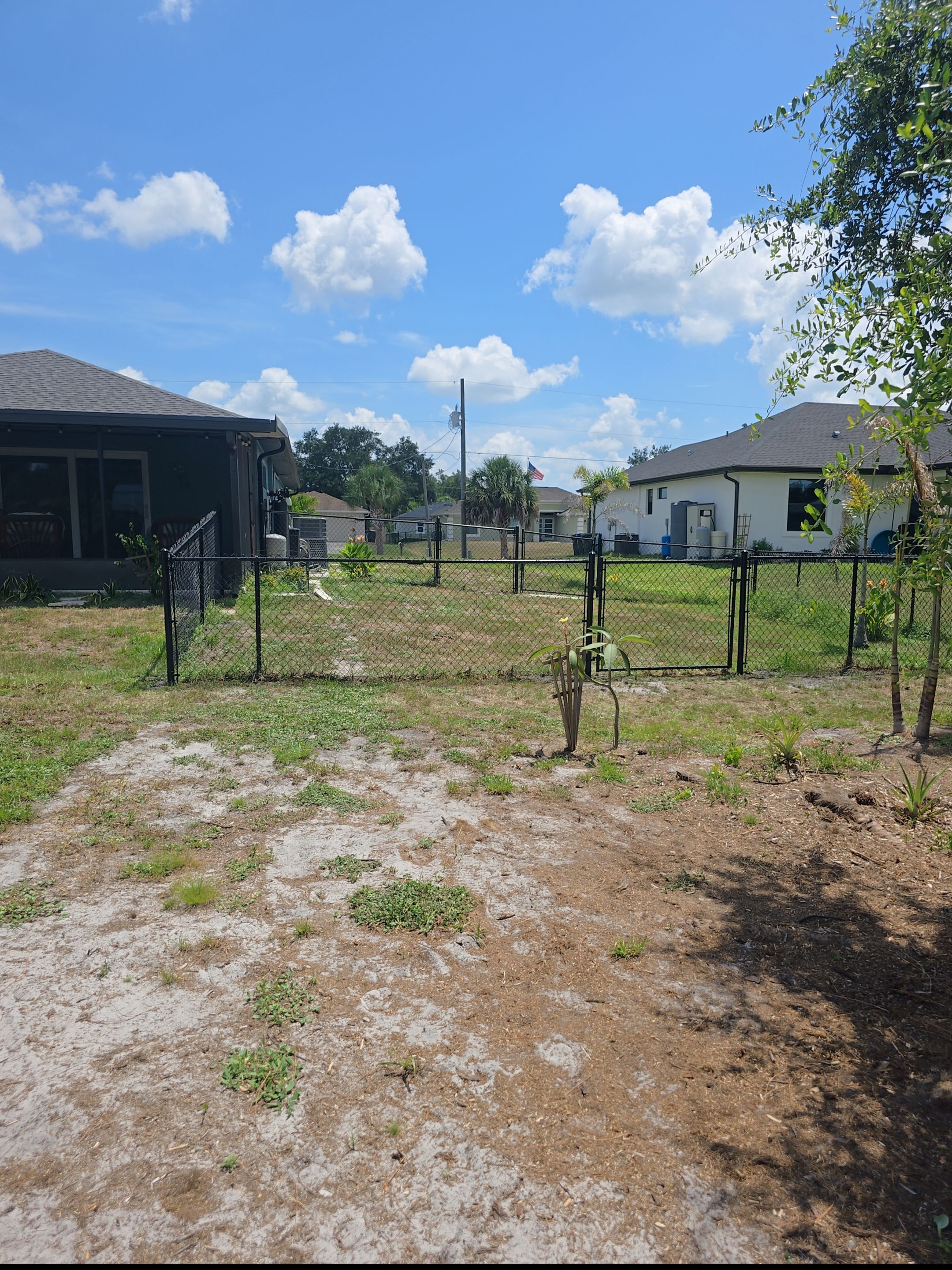 Black Vinyl-Coated Chain Link Fence and Rolling Gate Installation in North Port by True Fence LLC
