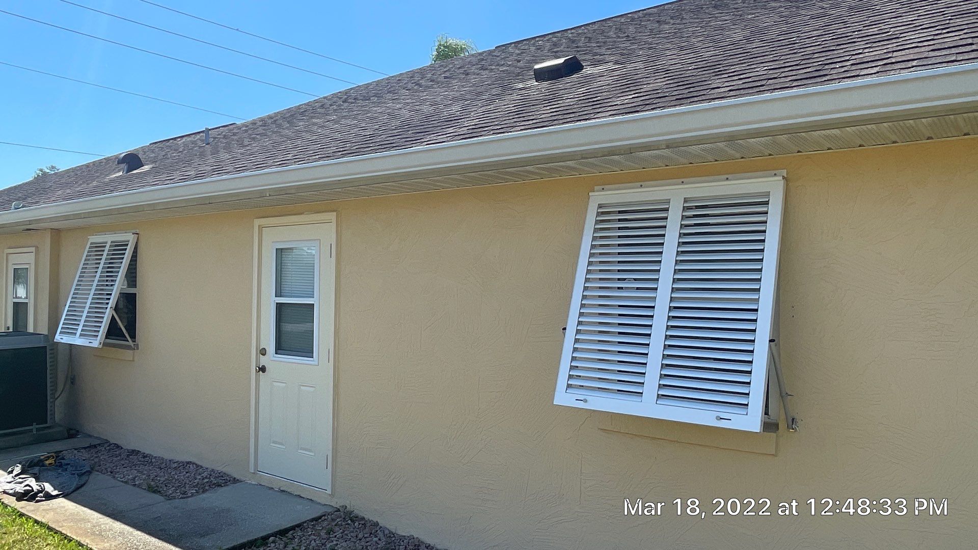 Bahama Shutters with front slide locking pin by Smart Guard Shutters