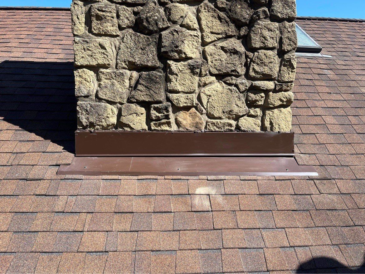 Shingle Roofing with Velux Skylight replacement and stone chimney flashing  by Secure Construction Company Inc