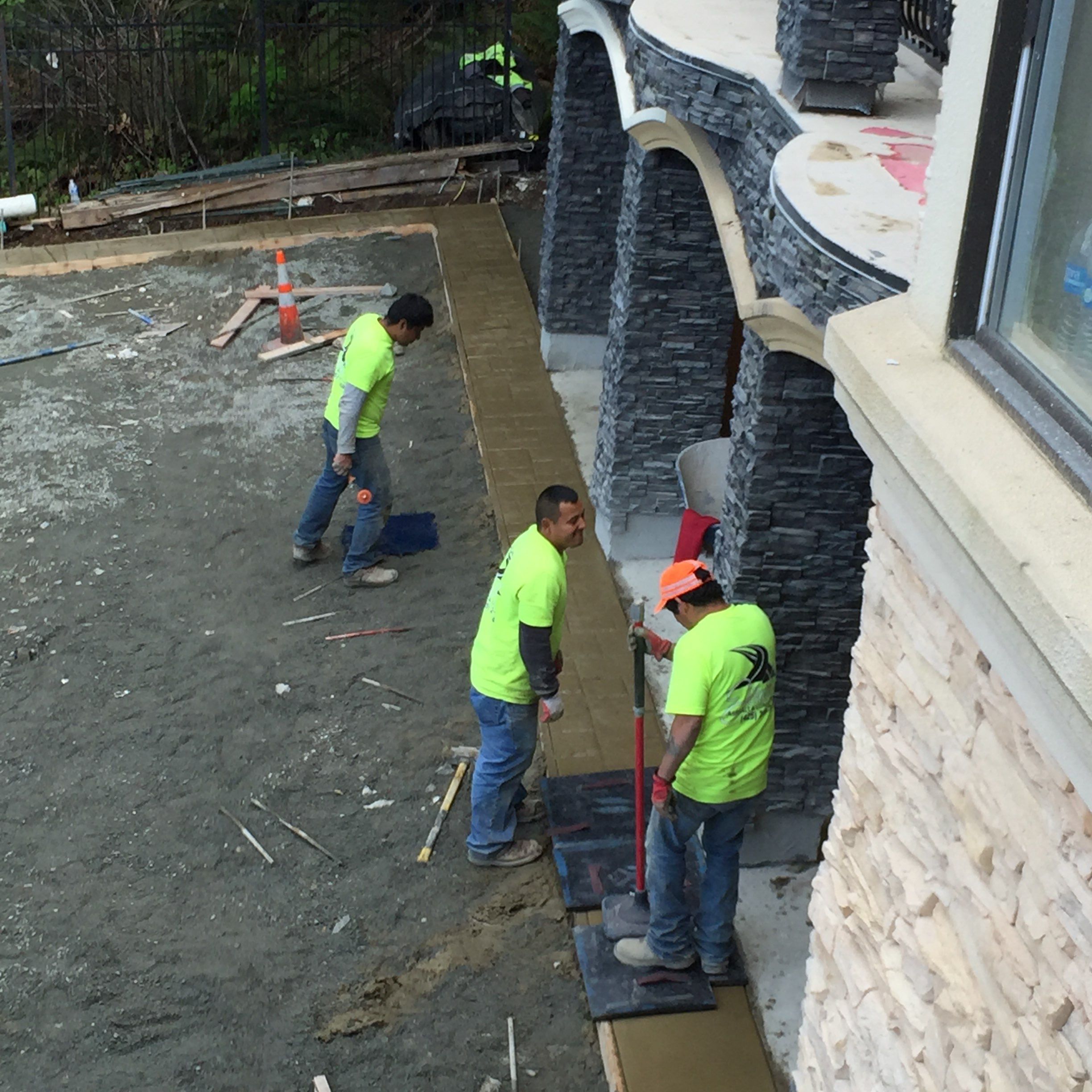 Asphalt Driveway and Stamped Concrete Patio Finish  by Jireh Asphalt & Concrete Inc 