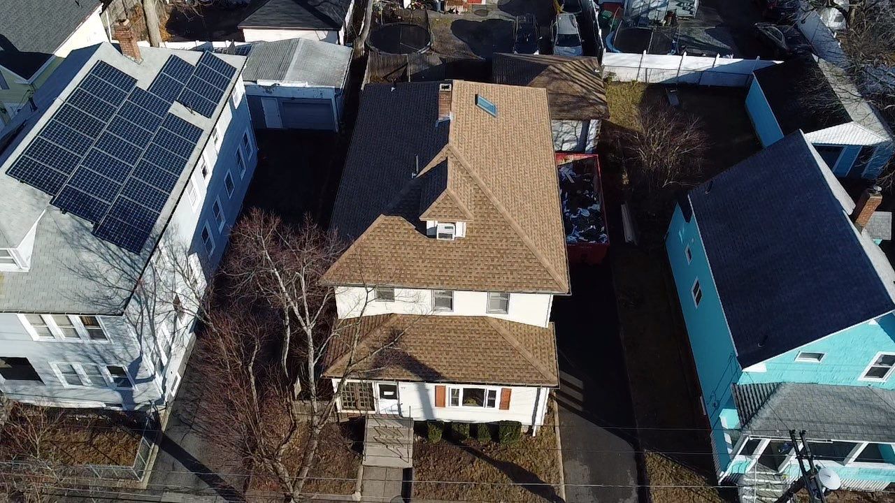 Roof Installation Roof Type: Hip Roof  Multi Family Home- 2 Story by Delarosa Construction & Design